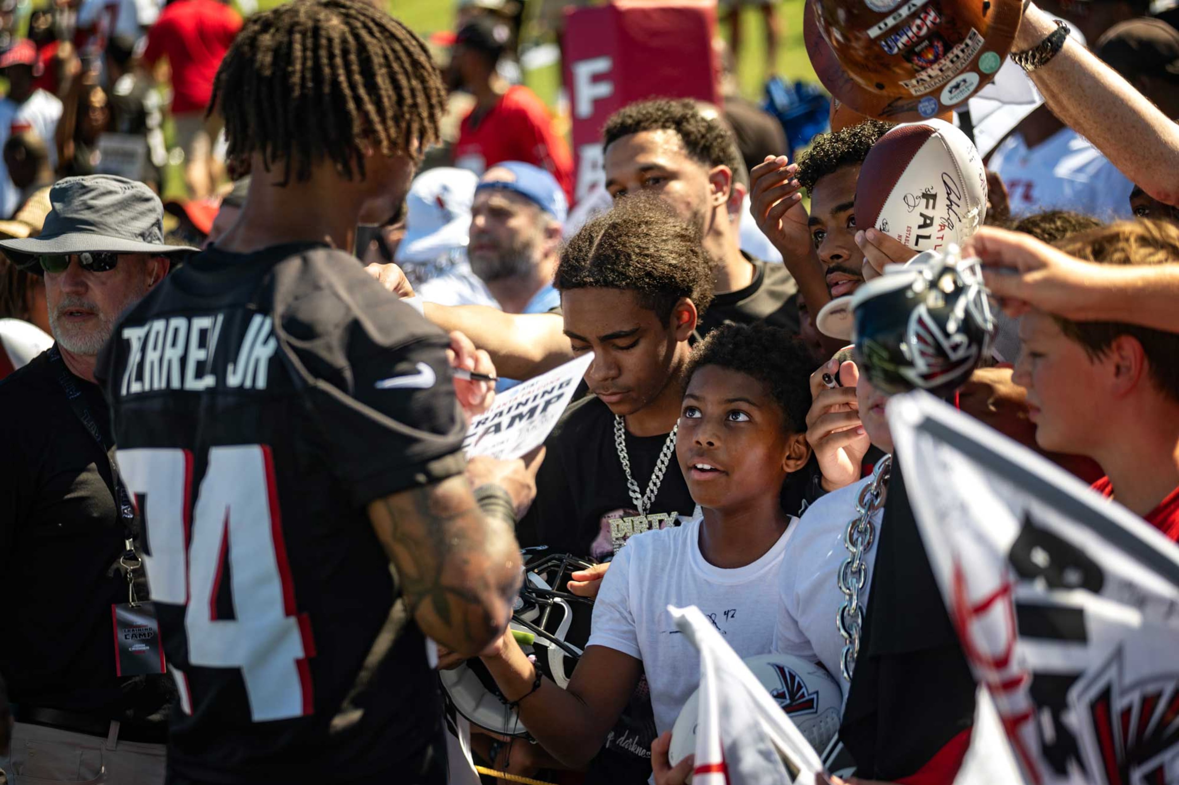 AJ Terrell Jr. signs autographs for fans at Falcons training camp, Flowery Branch, GA. Archival pigment print. (Courtesy of Sheila Pree Bright)