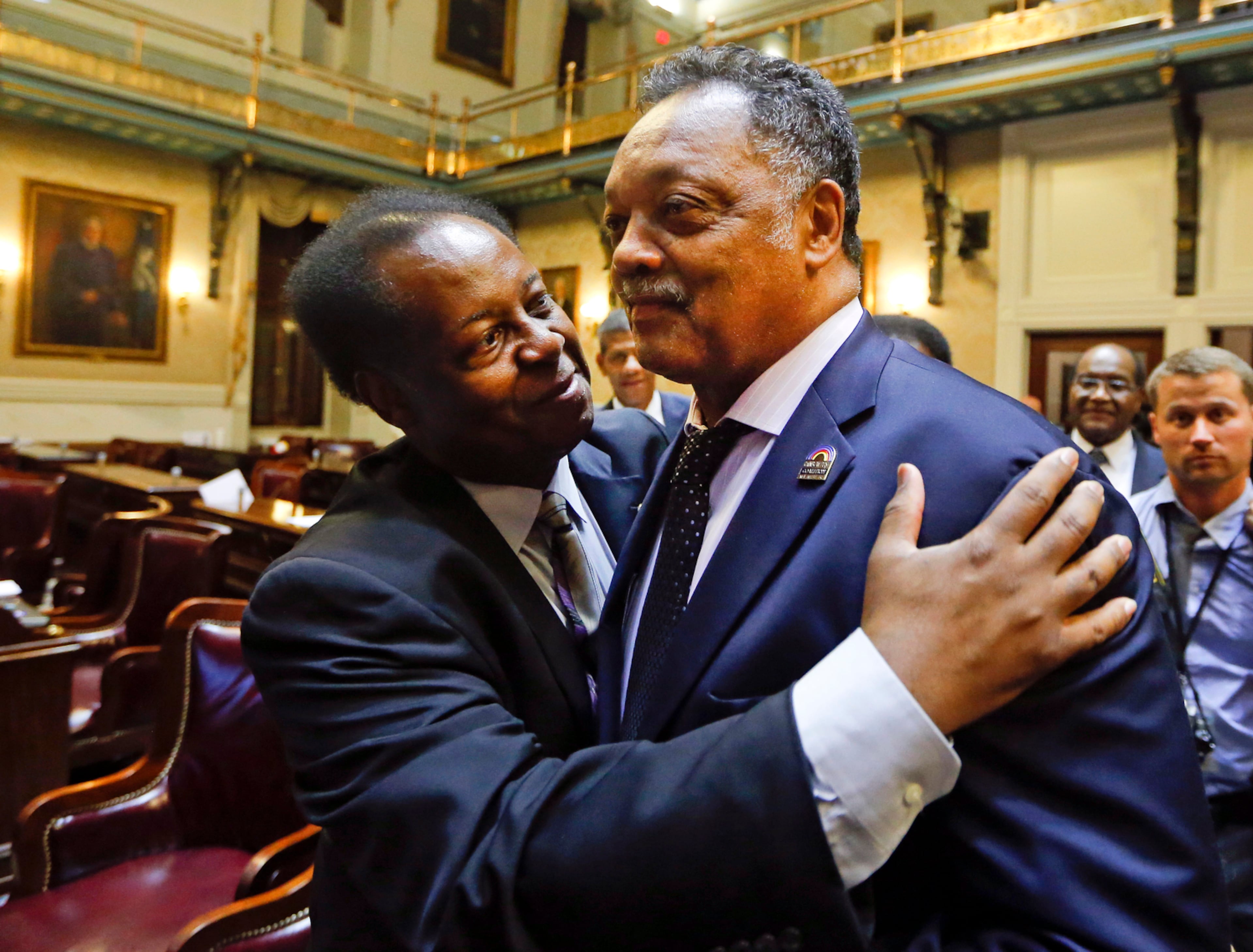 Rep. Carl Anderson, D-Georgetown (left) embraces Rev. Jesse Jackson after the House approved a bill removing the Confederate flag from the Capitol grounds early Thursday, July 9, 2015, in Columbia, S.C. (John Bazemore/AP)