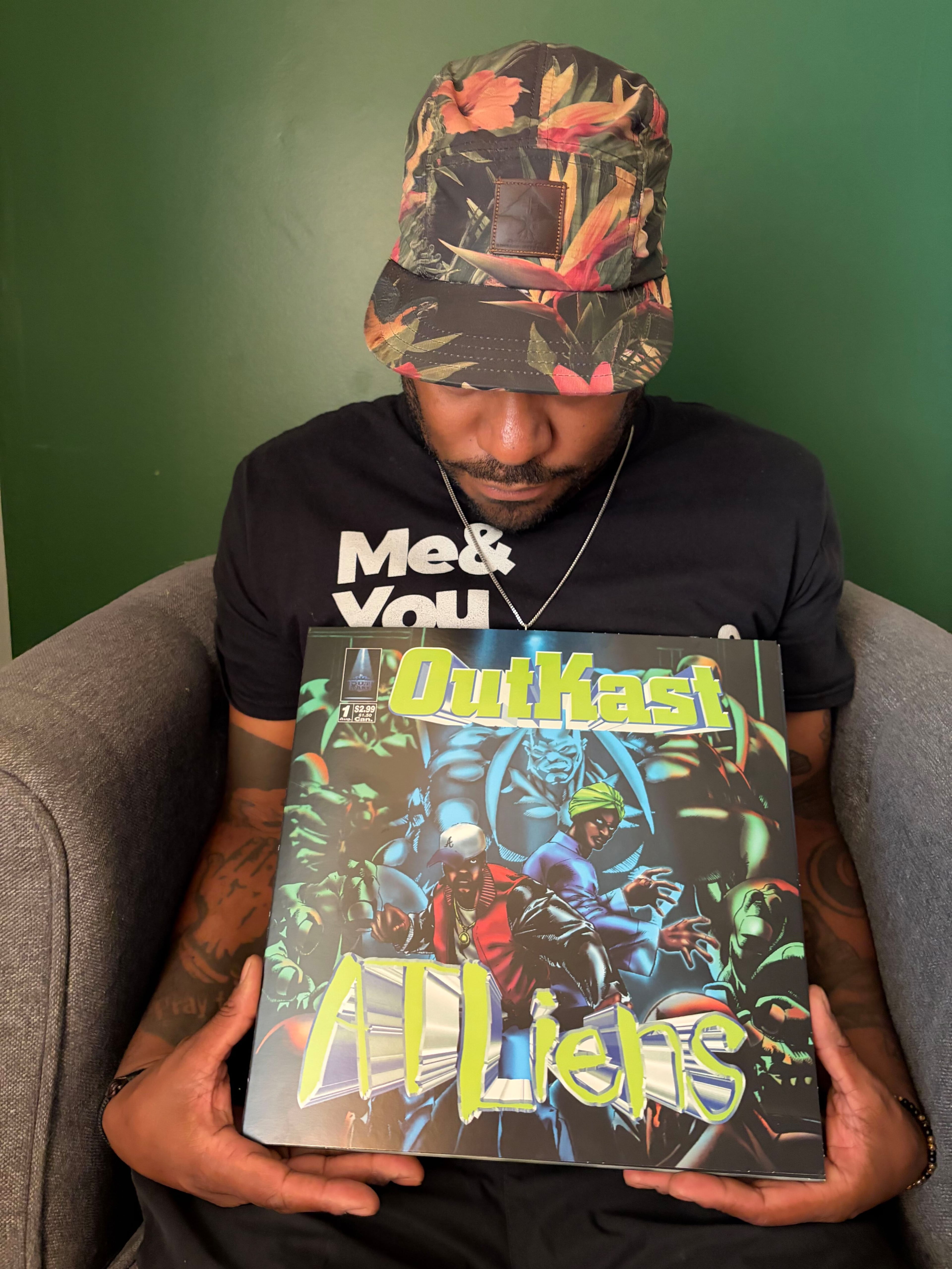 AJC and UATL senior reporter Gavin Godfrey holds one of his copies of Outkast's "ATLiens." (Gavin Godfrey/AJC)