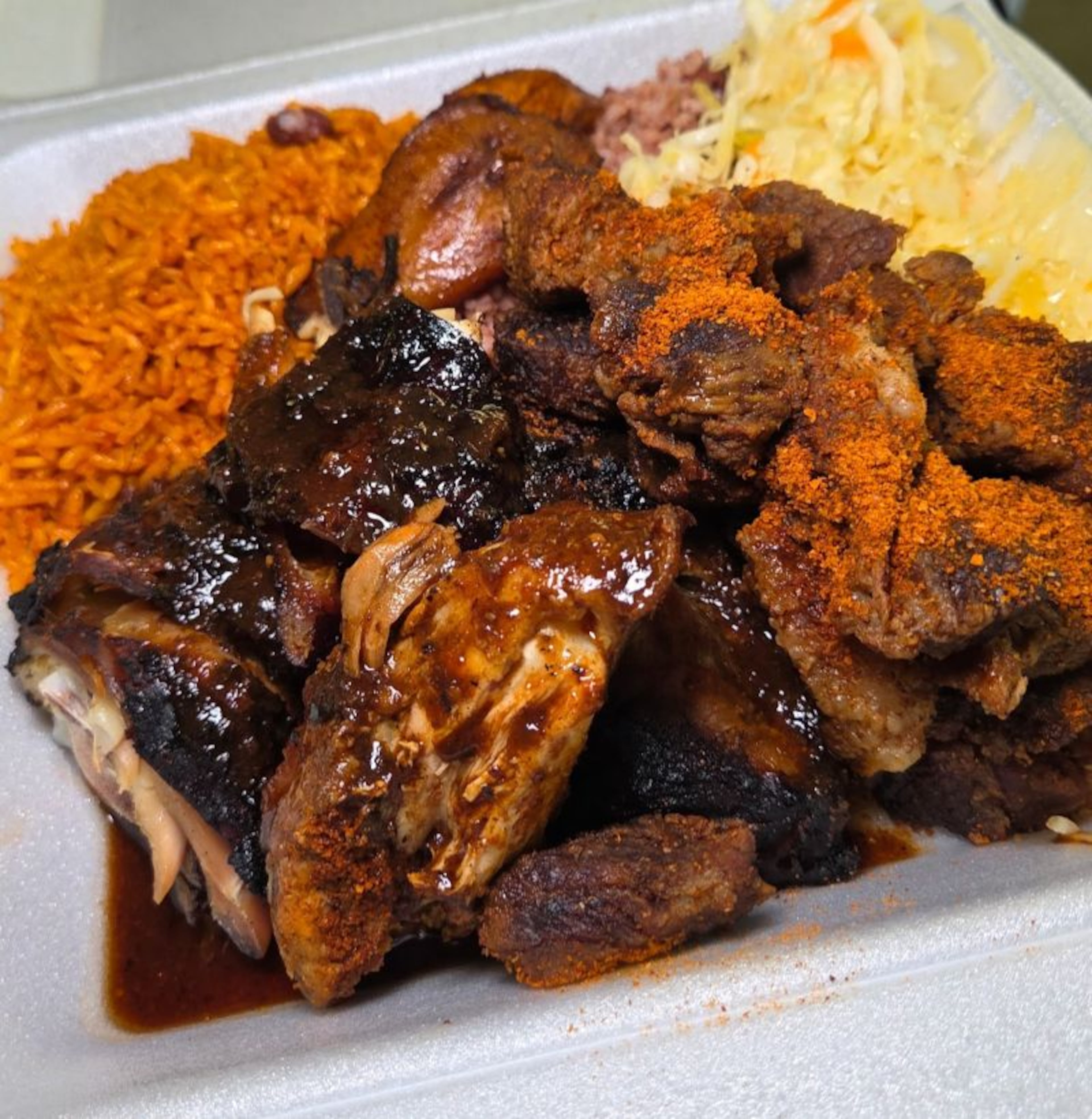 Tribe and Spice, a Ghanaian and Jamaican fusion restaurant located in Atlanta's West End community, is serving jerk chicken with rice and peas at Nosh Culinary Showcase at Uptown Atlanta, Saturday, Oct. 24. (Courtesy of Nancy Davordzi)