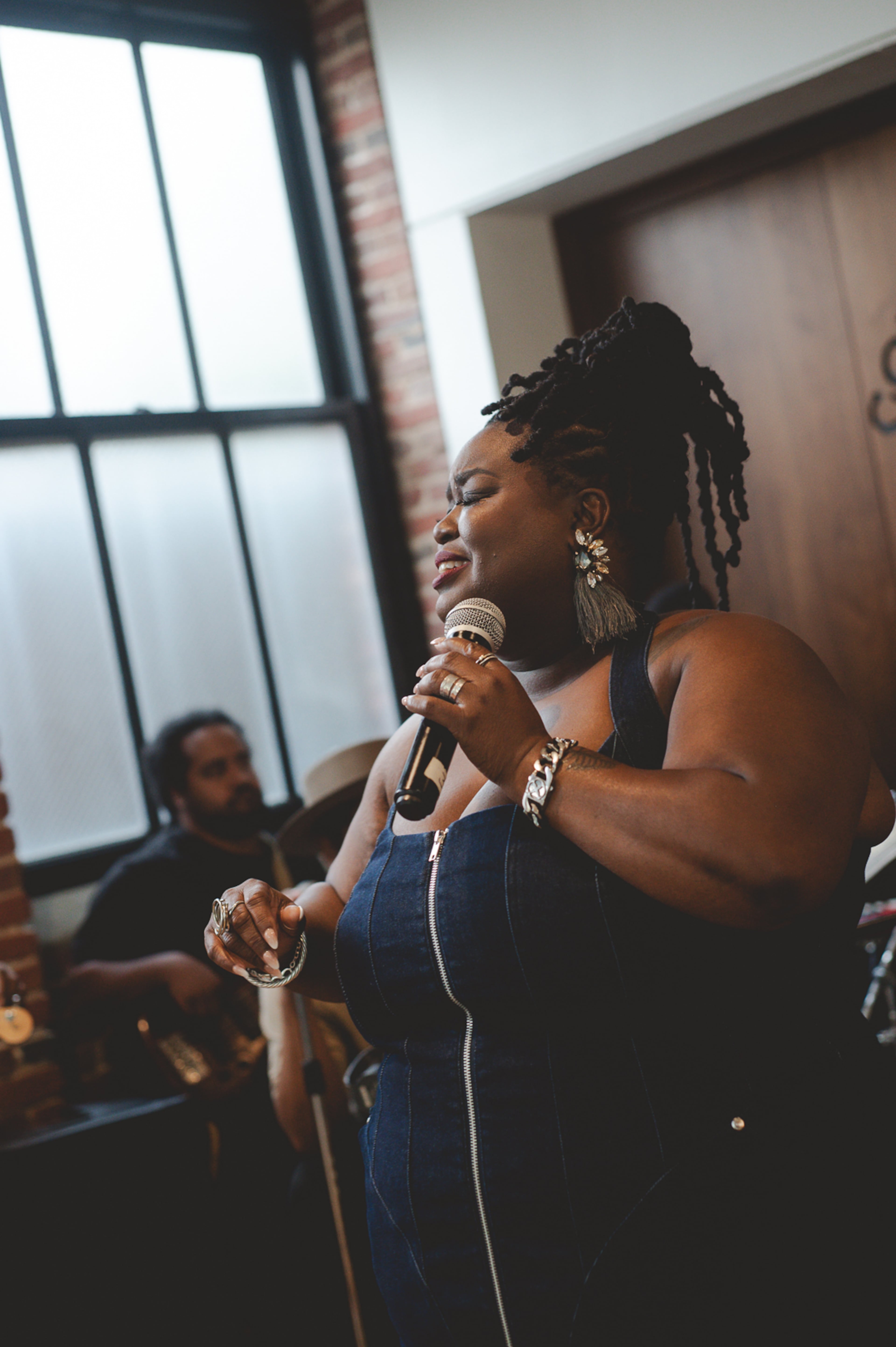 Monica Simpson, executive director of SisterSong Women of Color Reproductive Justice Collective, sings at “For the Love of Culture Vol. 1” on Saturday, Sept. 20, 2025, at Constellations ATL in Sweet Auburn. (Courtesy of SisterSong)