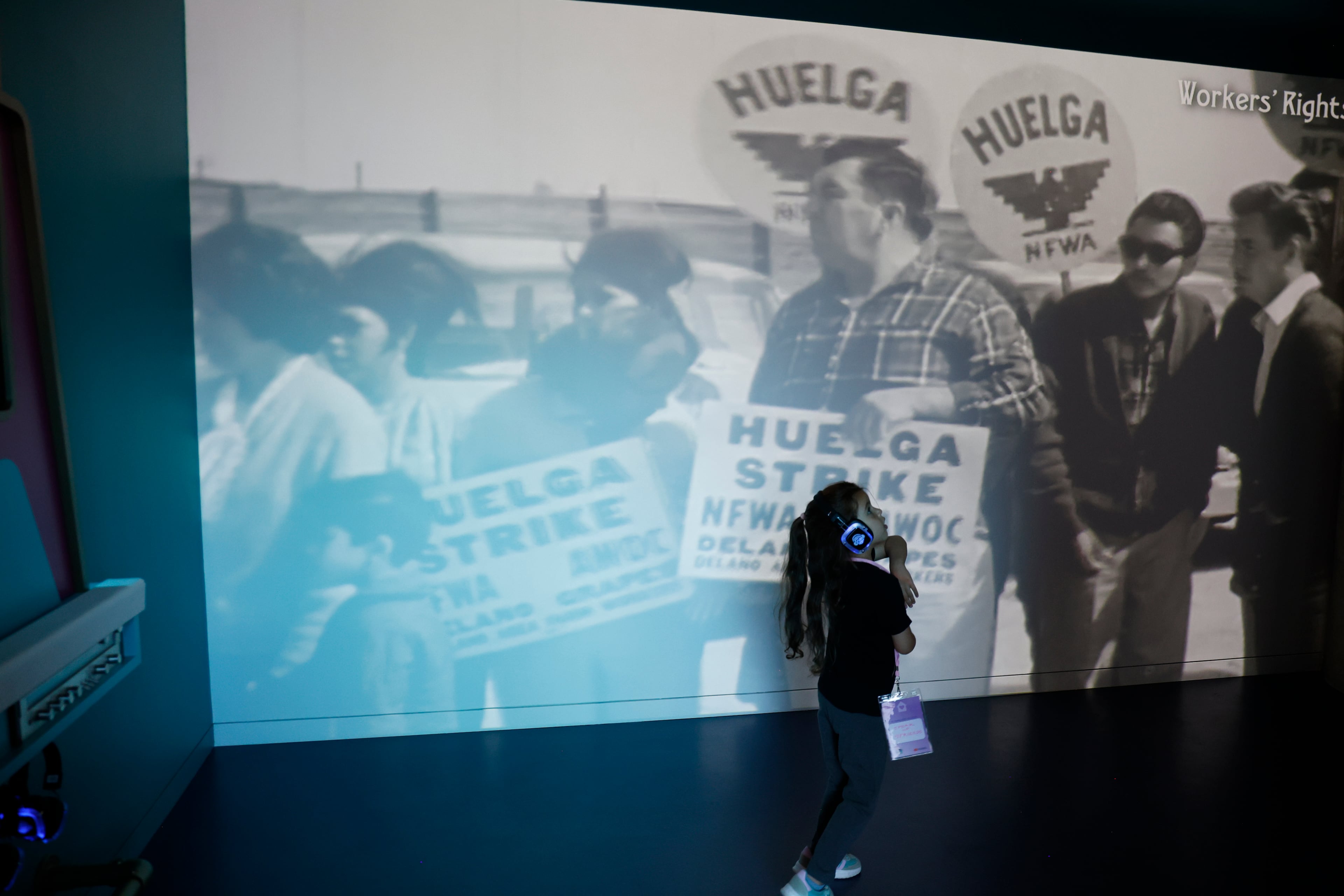 Four-year-old McKenzie Luse listens through headphones to hits of the Black Power Movement at the Juke Box in the Change Agent Adventure: Children’s Gallery. (Akili-Casundria Ramsess/EyeAkili Media)