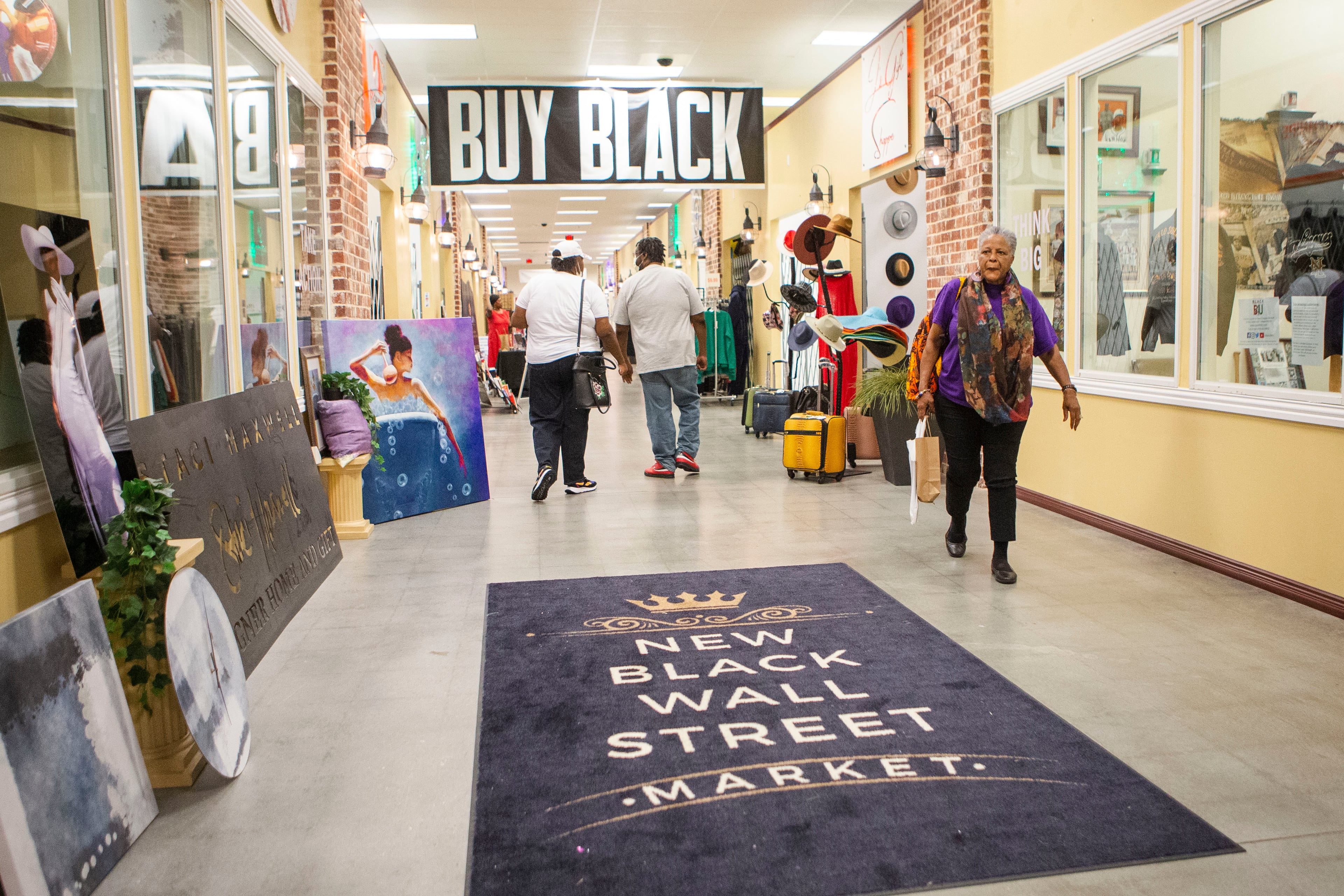 Customers walk among the storefronts at the New Black Wall Street Market, on Saturday, October 15, 2022. (Christina Matacotta for the AJC)