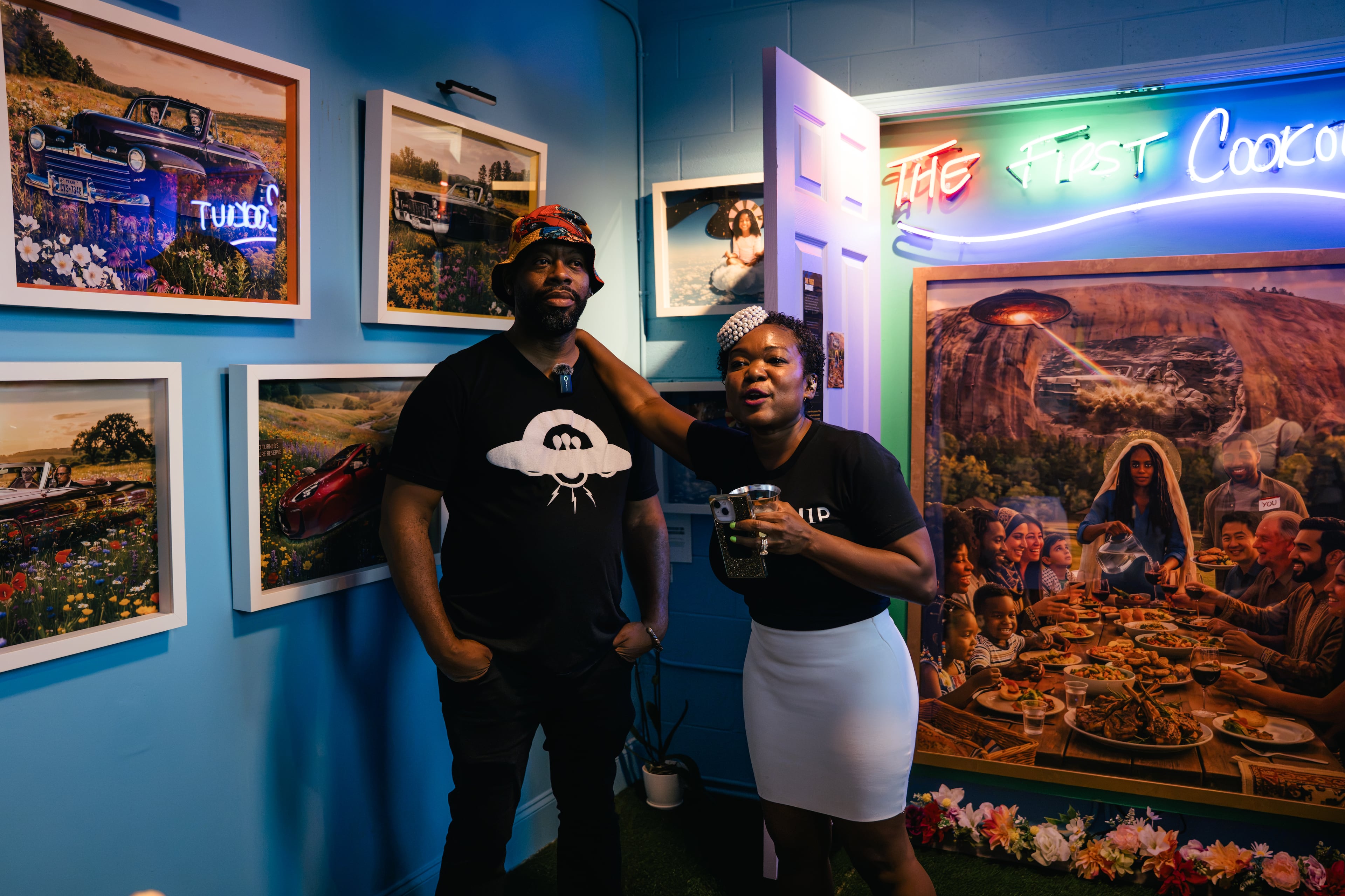 Artist Fabian Williams, left, and his wife and co-creator, Sindy Guerrero-Williams, right, present the final room of “Mothership Sirius B” during a preview of the exhibit on Aug. 12, 2026, in Atlanta. The room imagines possible futures and features an installation titled “The First Cookout.” (Olivia Bowdoin/AJC)