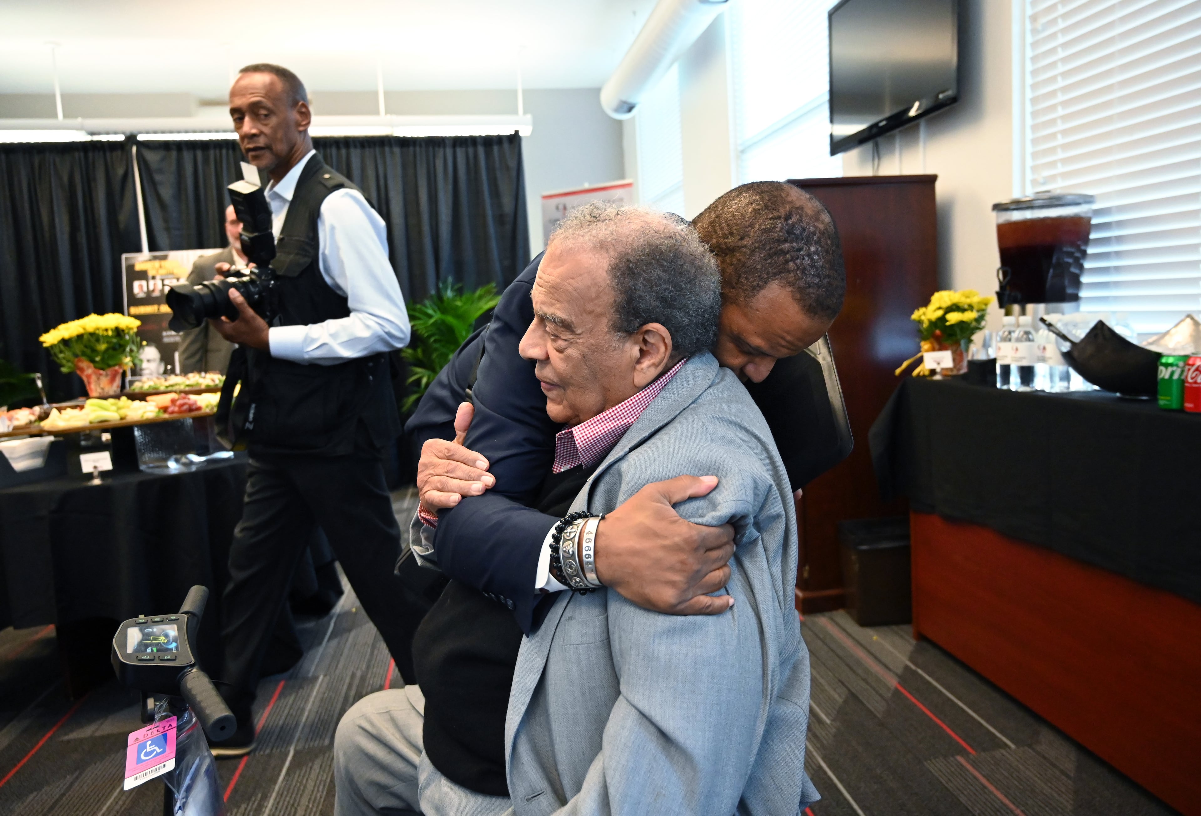 Ambassador Andrew Young gets a hug from John Hope Bryant, CEO of Operation HOPE, before a special panel conversation ahead of the world premiere of the MSNBC documentary “Andrew Young: The Dirty Work.” (Hyosub Shin/AJC)