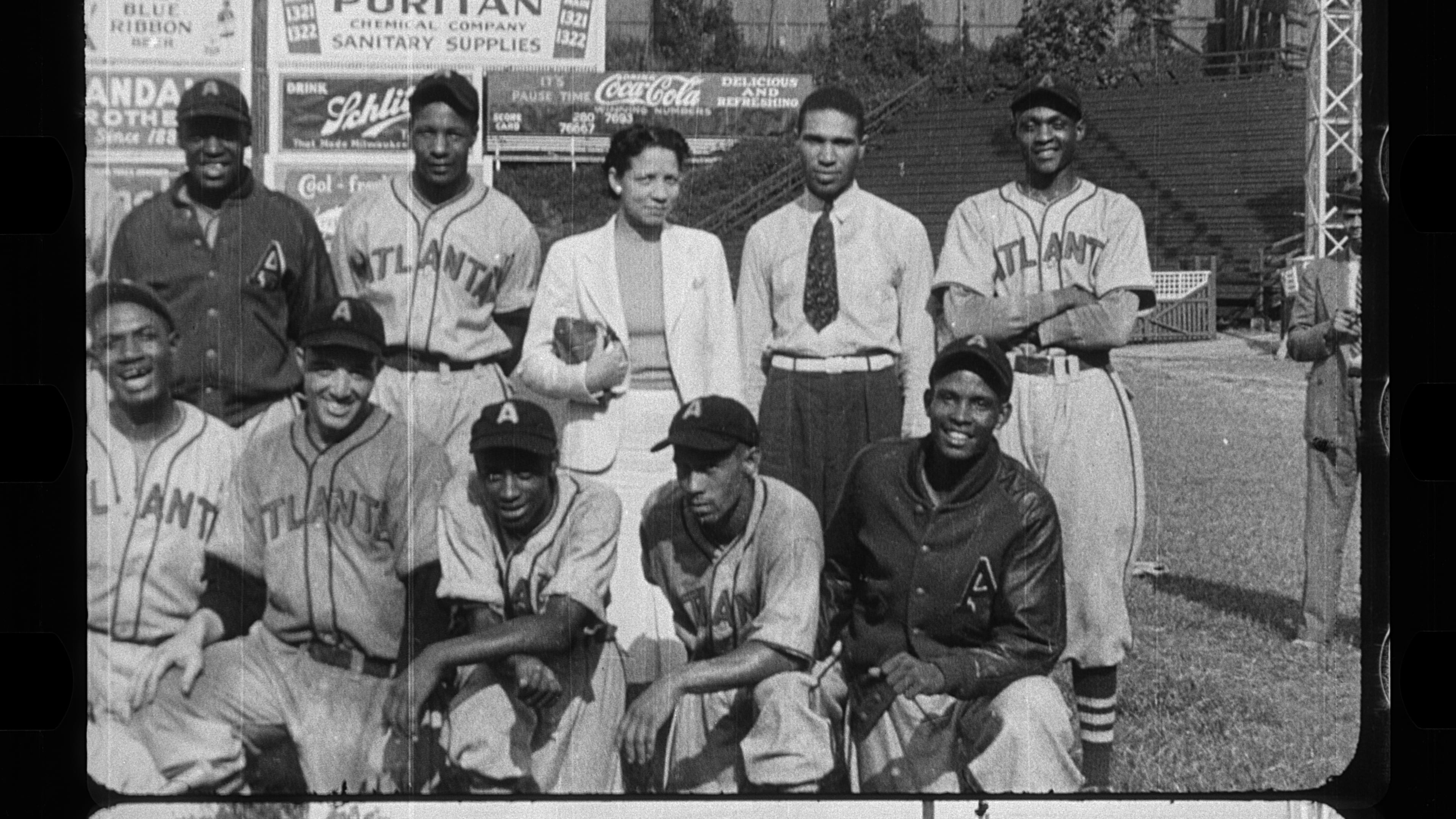 Produced by Atlanta Life Insurance Company, the film, "Parade of Progress of Colored Atlanta," celebrated the achievements of Black Atlantans during the Jim Crow era. It showcased thriving businesses, schools, churches and neighborhoods at a time when mainstream portrayals often ignored or distorted Black life. The 30-minute promotional newsreel presented a confident vision of community pride and economic advancement. It remains one of the most vivid visual records of Black Atlanta before the Civil Rights Movement. This image from the film features John and Billie Harden. In the 1930s, the couple purchased Atlanta's beloved Black Crackers baseball team. Using the money earned from their Auburn Avenue gas station, the couple bought equipment, uniforms, and even a bus for the team. Morehouse and Morris Brown Colleges supplied many of the players, and the games were often played on their fields to save money. (Courtesy of the Atlanta History Center)