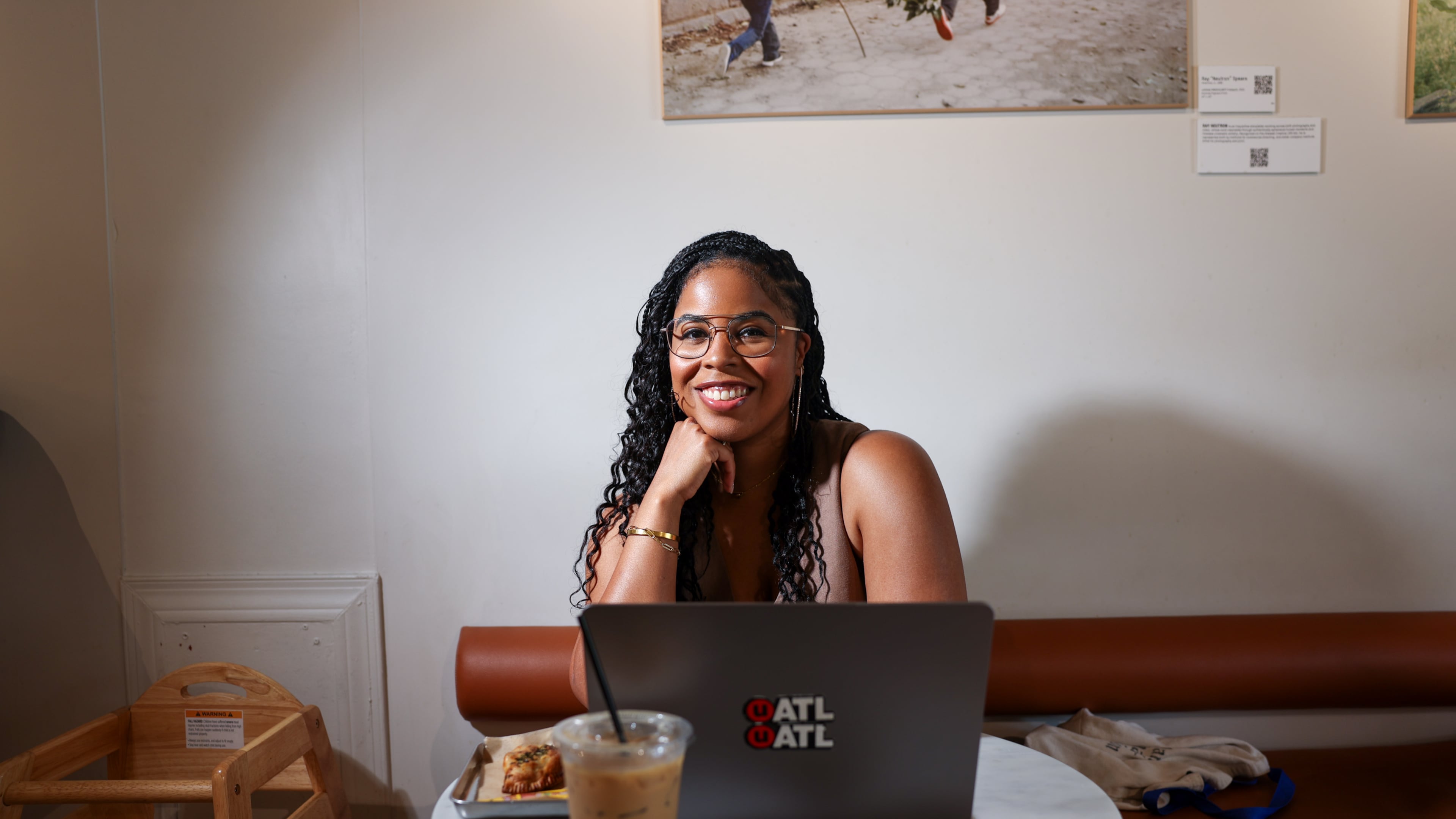 AJC multimedia journalist Najja Parker sets up shop at Portrait Coffee on Wednesday, Aug. 19, 2026, in Atlanta. It has become her temporary office more times than she can count. (Arvin Temkar/AJC)