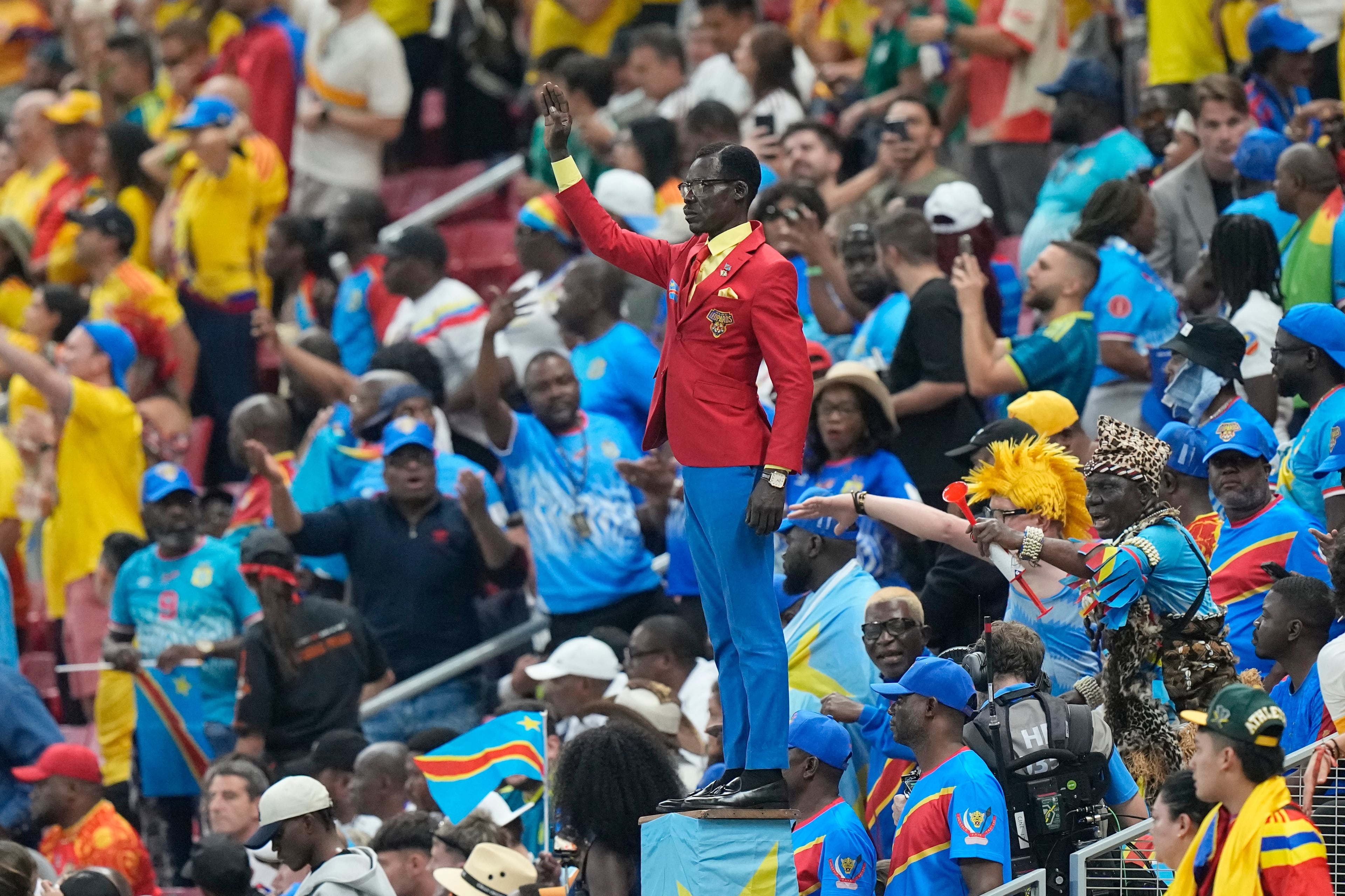 Congo supporter Michel Nkuka Mboladinga poses as a statue of the country's assassinated independence hero Patrice Lumumba ahead of the World Cup match against Colombia in Mexico on Tuesday, June 23, 2026. (Fernando Llano/AP)