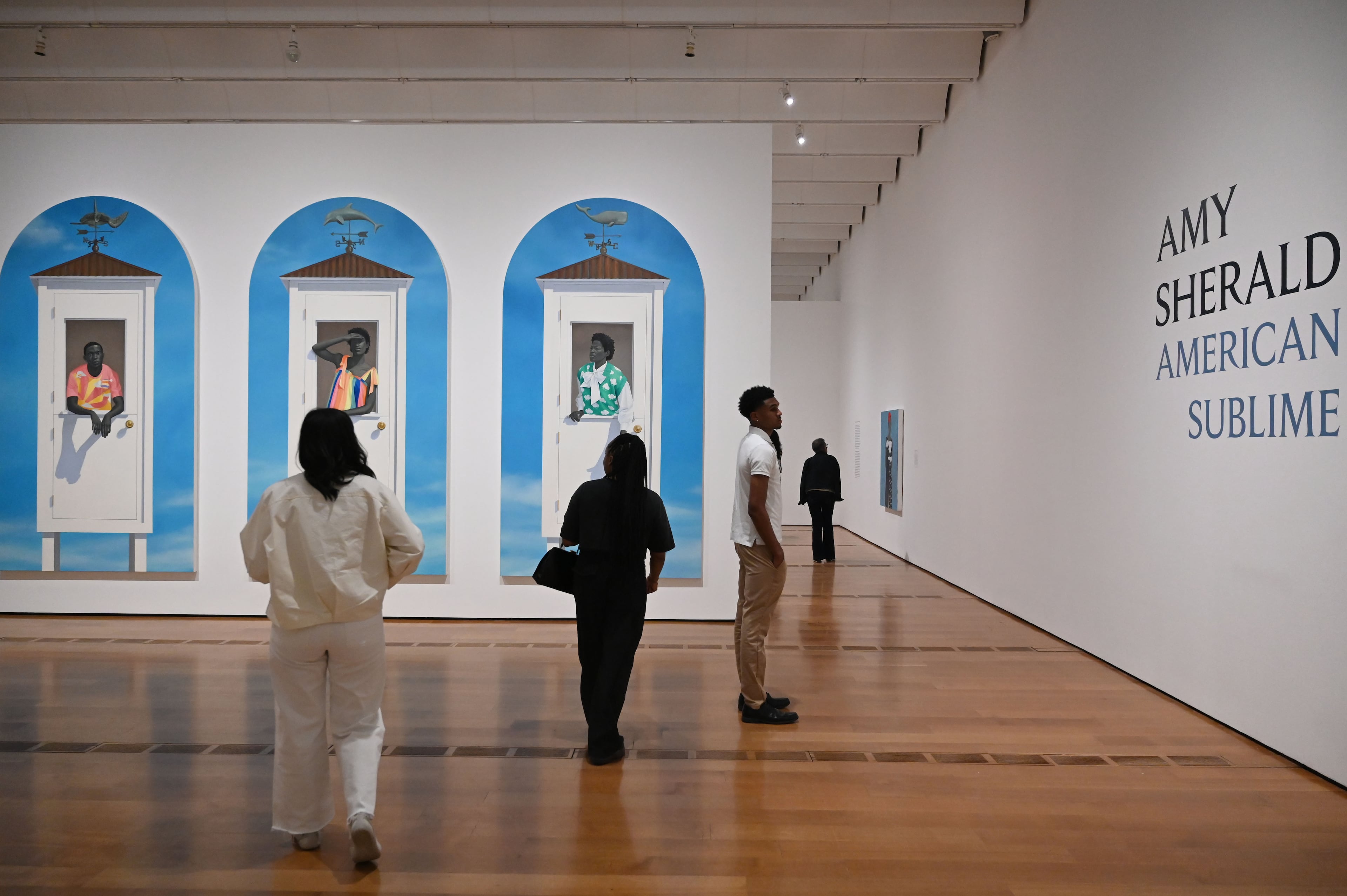 People walk through Sherald’s “American Sublime” exhibition at the High Museum of Art on Friday, May 15, 2026, in Atlanta. (Hyosub Shin/AJC)