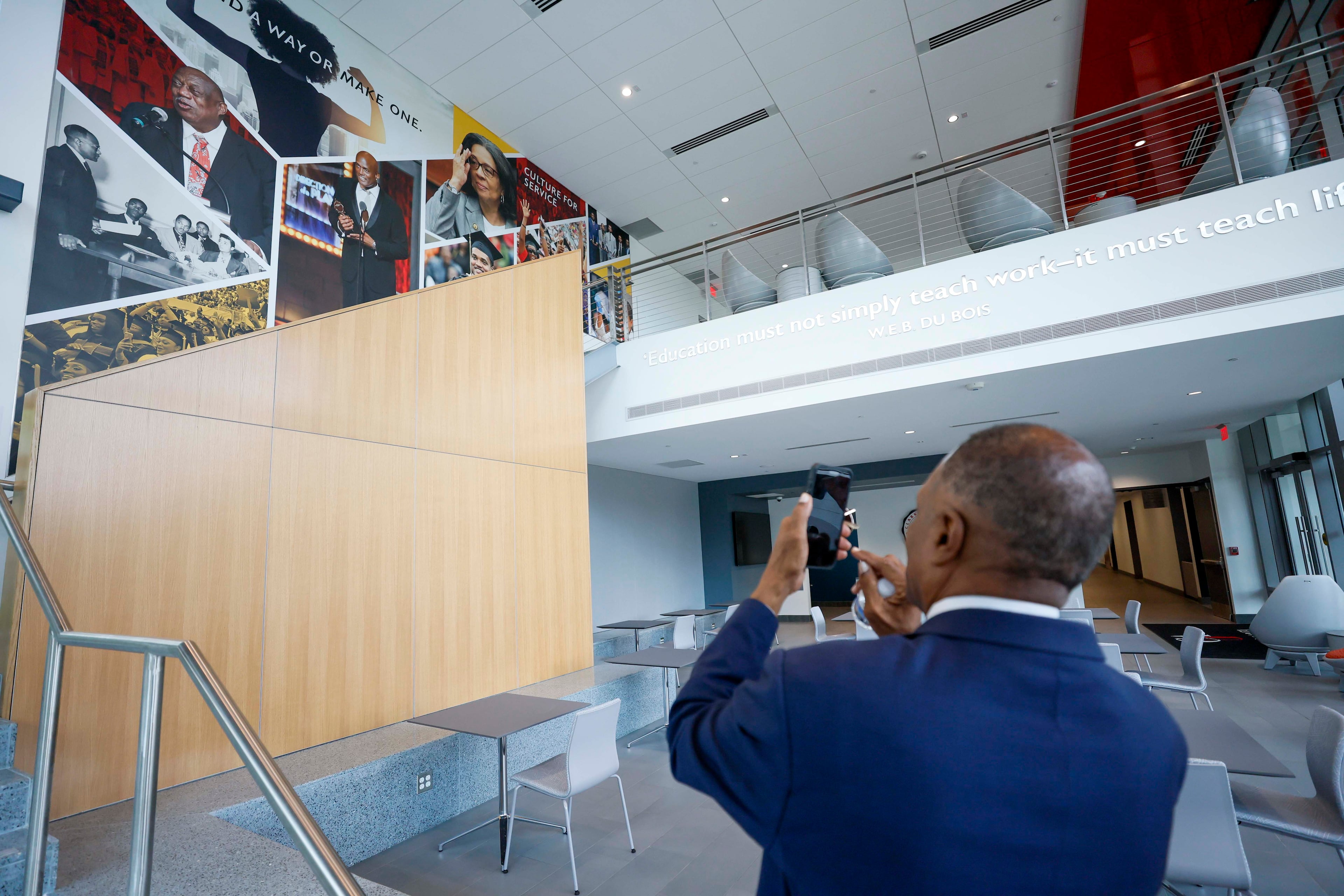 Clark Atlanta University President George T. French Jr. takes a photo of a mural as he arrives at the school's new Student Success Center on Wednesday, Sept. 2, 2026. (Miguel Martinez/AJC)