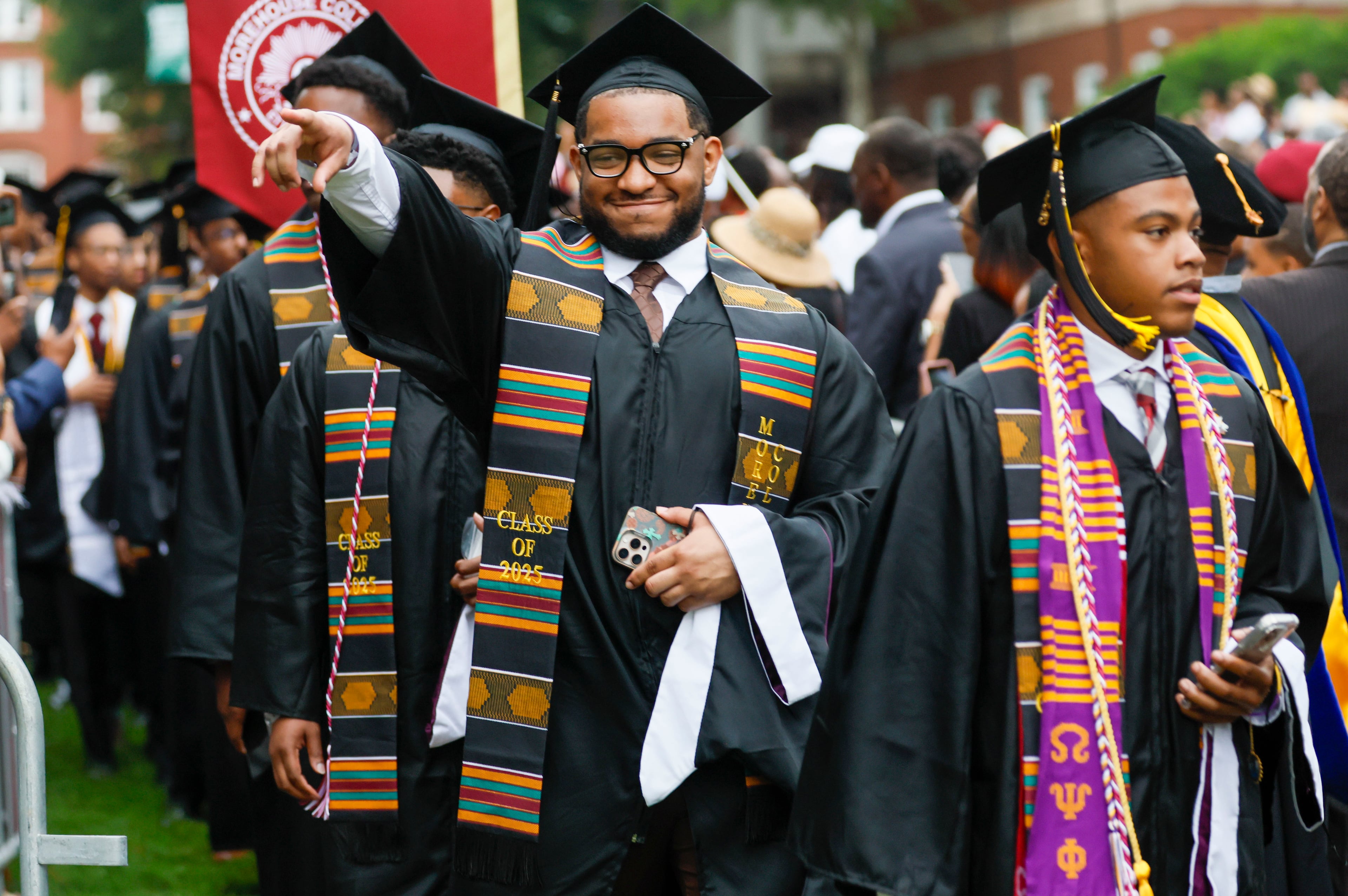 A graduate reacts to family members as he enters the ceremony during Morehouse College's 141st Commencement Ceremony on Sunday, May 18, 2025. The school has seen a spike in interest in recent years, receiving a record-high number of applications.
(Miguel Martinez/ AJC)