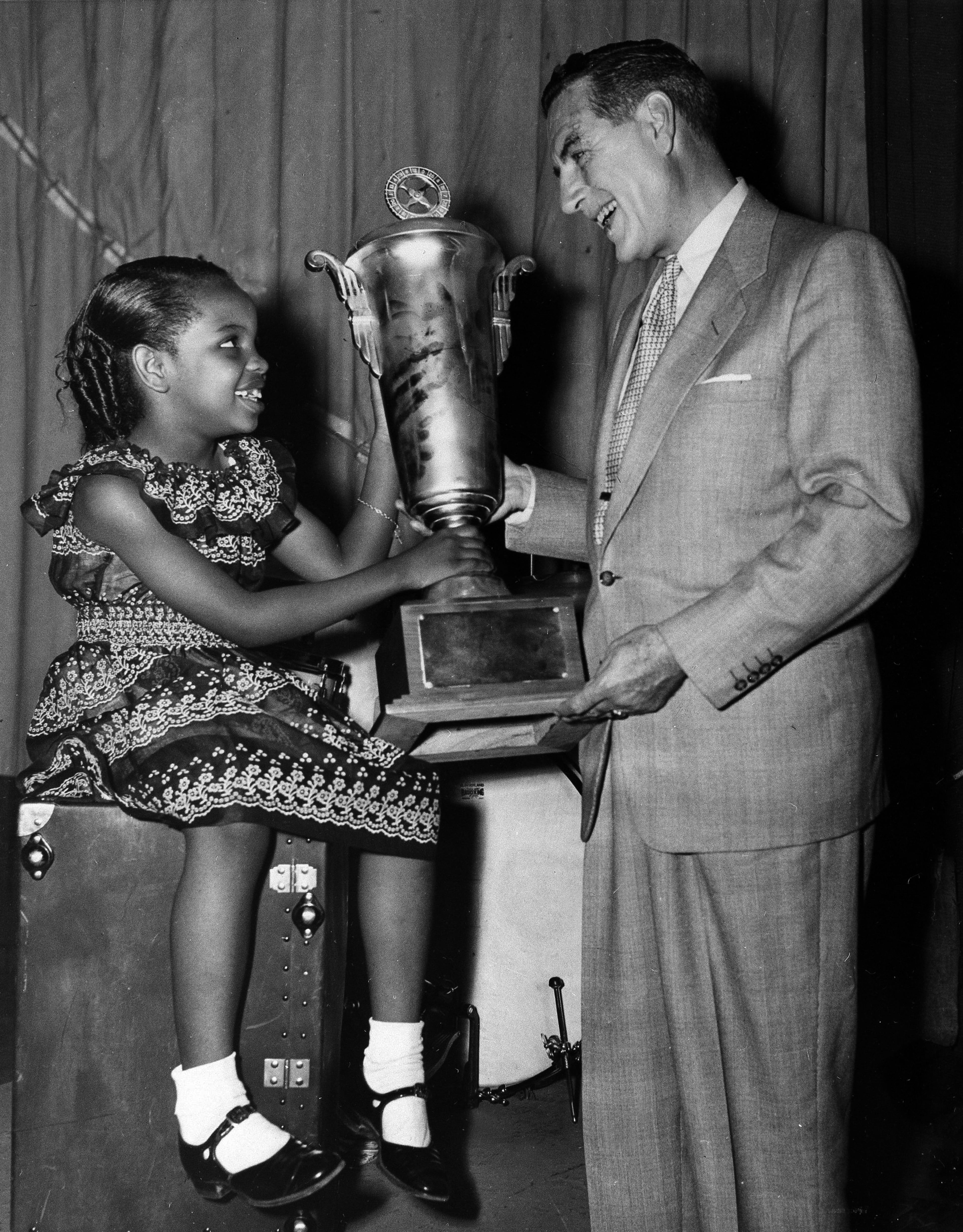 Ted Mack, right, master of ceremonies for "The Original Amateur Hour," hands a gold trophy to 8-year-old Gladys Knight in New York, July 1, 1952, after Knight was voted winner of three nationwide broadcasts of the TV talent show. Kultur Video released a two-DVD set in 2005, titled "The Original Amateur Hour," featuring clips of now-famous entertainers like Knight who got their starts on the show. (The Associated Press)