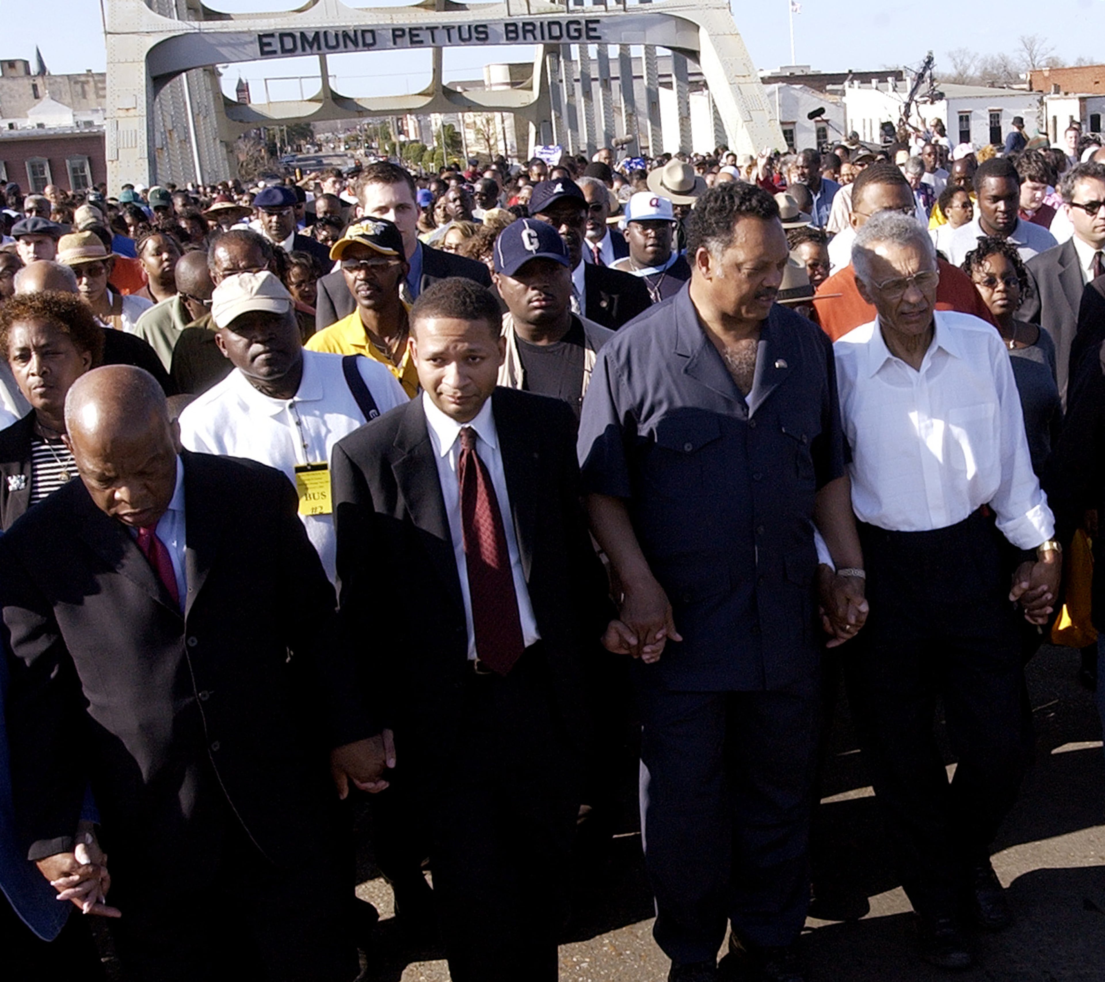 U.S. Rep. John Lewis (from left), D-Ga., U.S. Rep. Artur Davis, D-Ala., the Rev. Jesse Jackson and the Rev. C.T. Vivian hold hands as they lead hundreds of marchers across the Edmund Pettus Bridge on Sunday, March 6, 2004, in Selma, Ala. (Dave Martin/AP 2004)