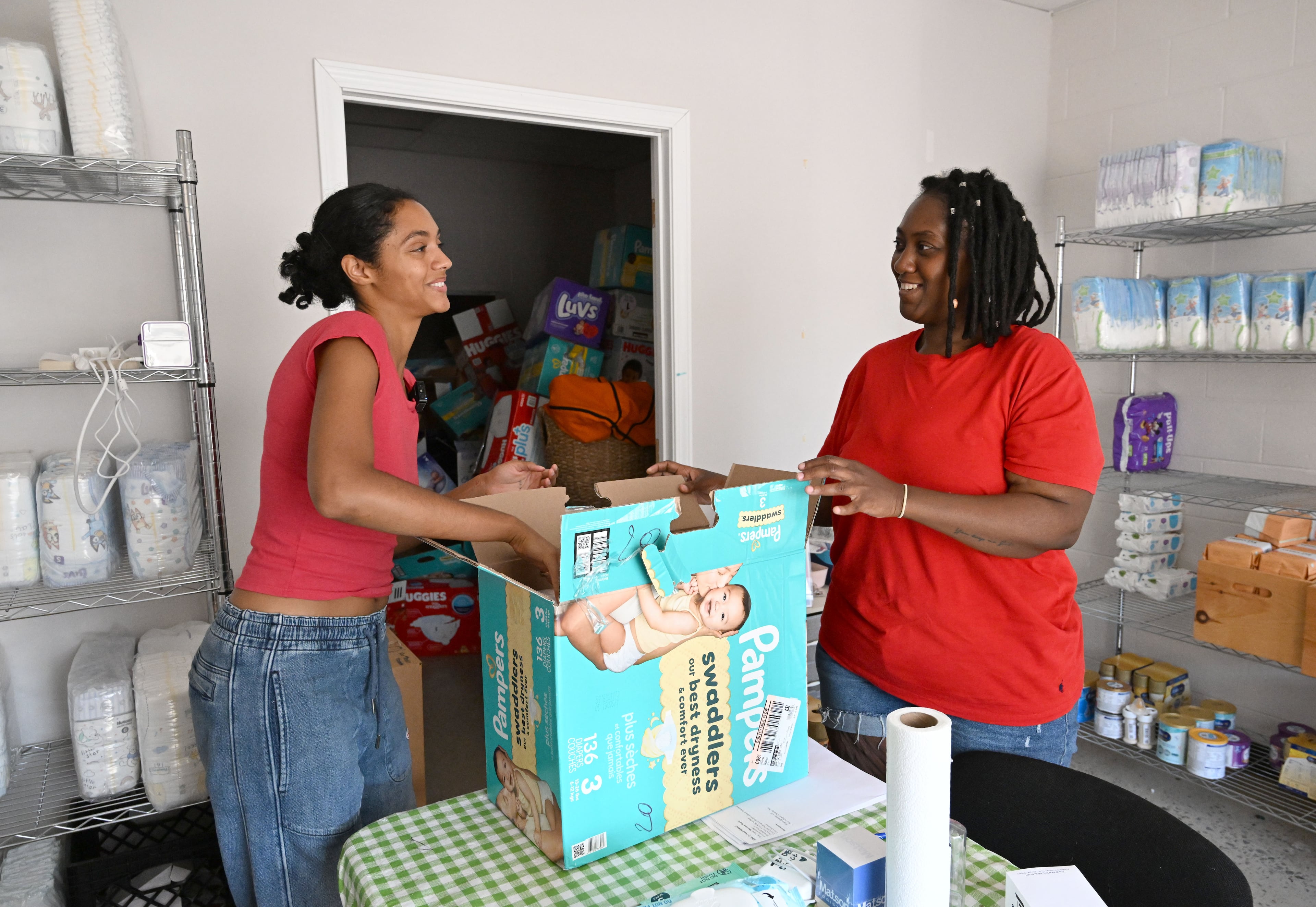 Jaycina Almond (left) talks with Nylasha Miller as Miller arrives to pick up baby essentials at the Tender Foundation's Diaper Bank on Saturday, July 11, 2026, in East Point. (Hyosub Shin/AJC)