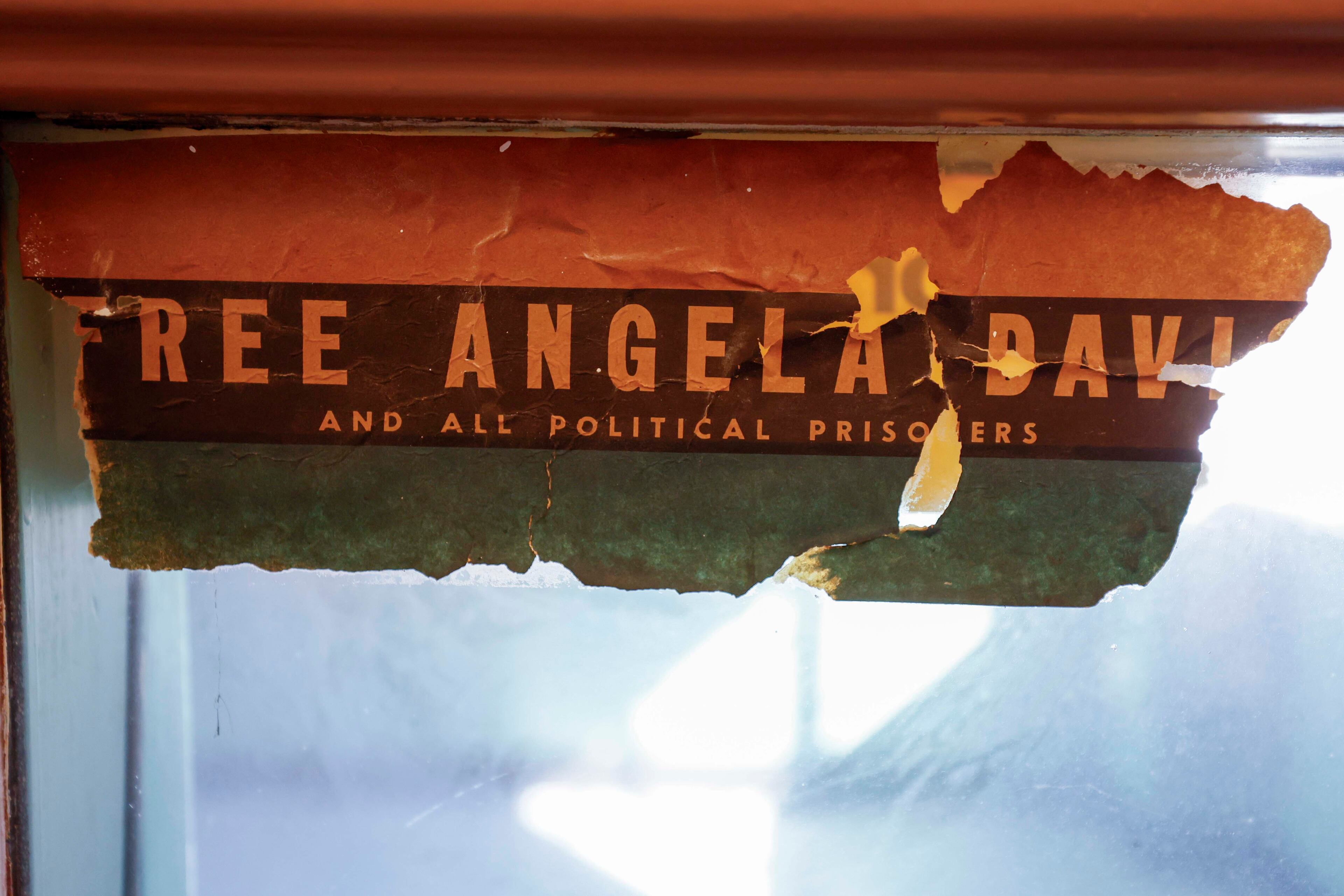 A sticker demanding officials to Free Angela Davis was left for historical purposes inside the newly renovated radio station cabin at the Prince Hall Masonic Lodge. (Miguel Martinez/AJC)