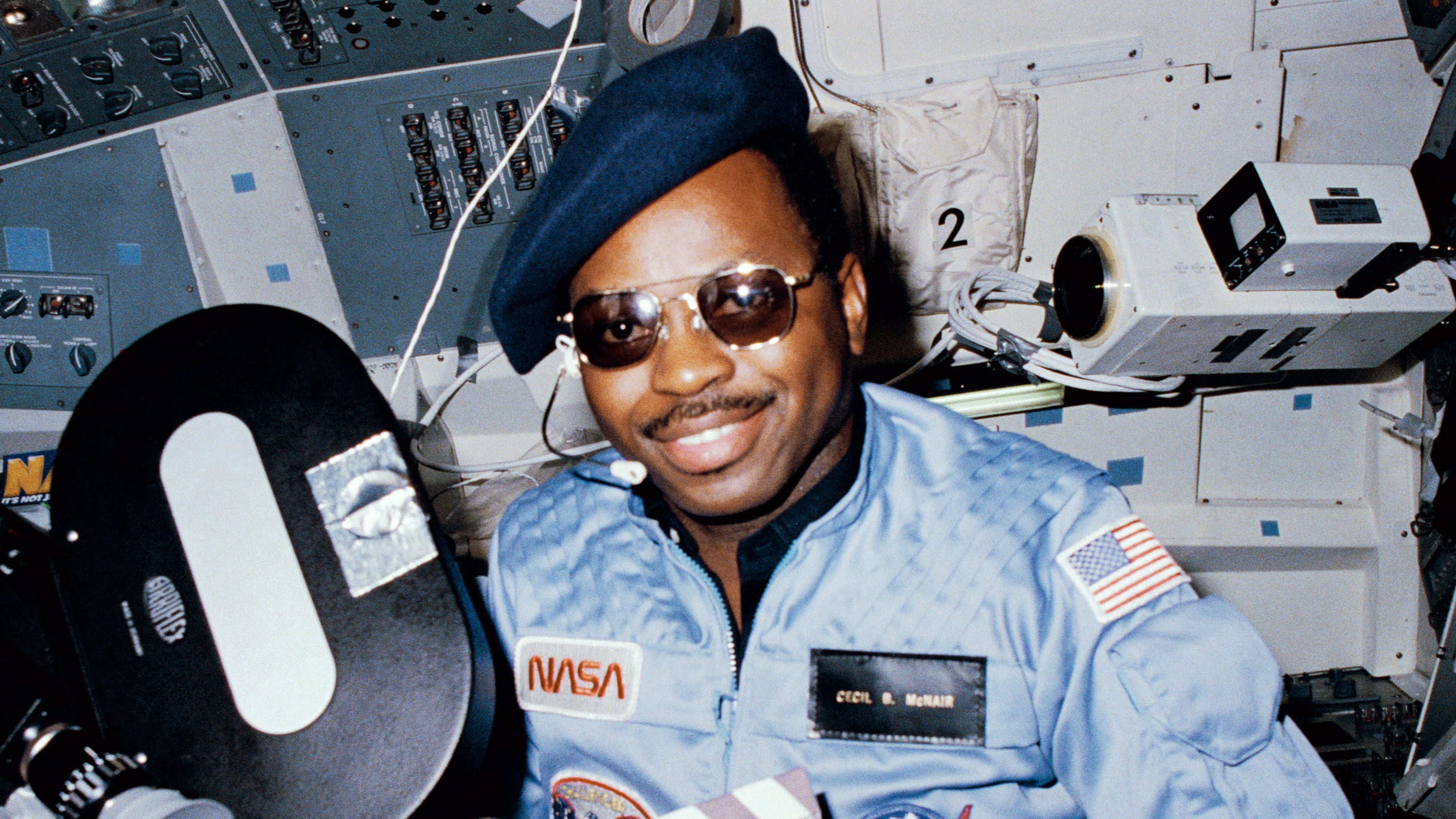 Astronaut Ronald McNair doubles as "director" for a movie being "produced" aboard the Earth-orbiting space shuttle Challenger in February 1984. McNair’s name tag ( "Cecil B. McNair"), beret and slate were all humorous props for application of a serious piece of cargo on the eight day flight: the Cinema 360 camera. In 1986, McNair was the mission specialist on the Challenger when it exploded 73 seconds after launch, killing all aboard. (HUM Images/Universal Images Group via Getty Images)