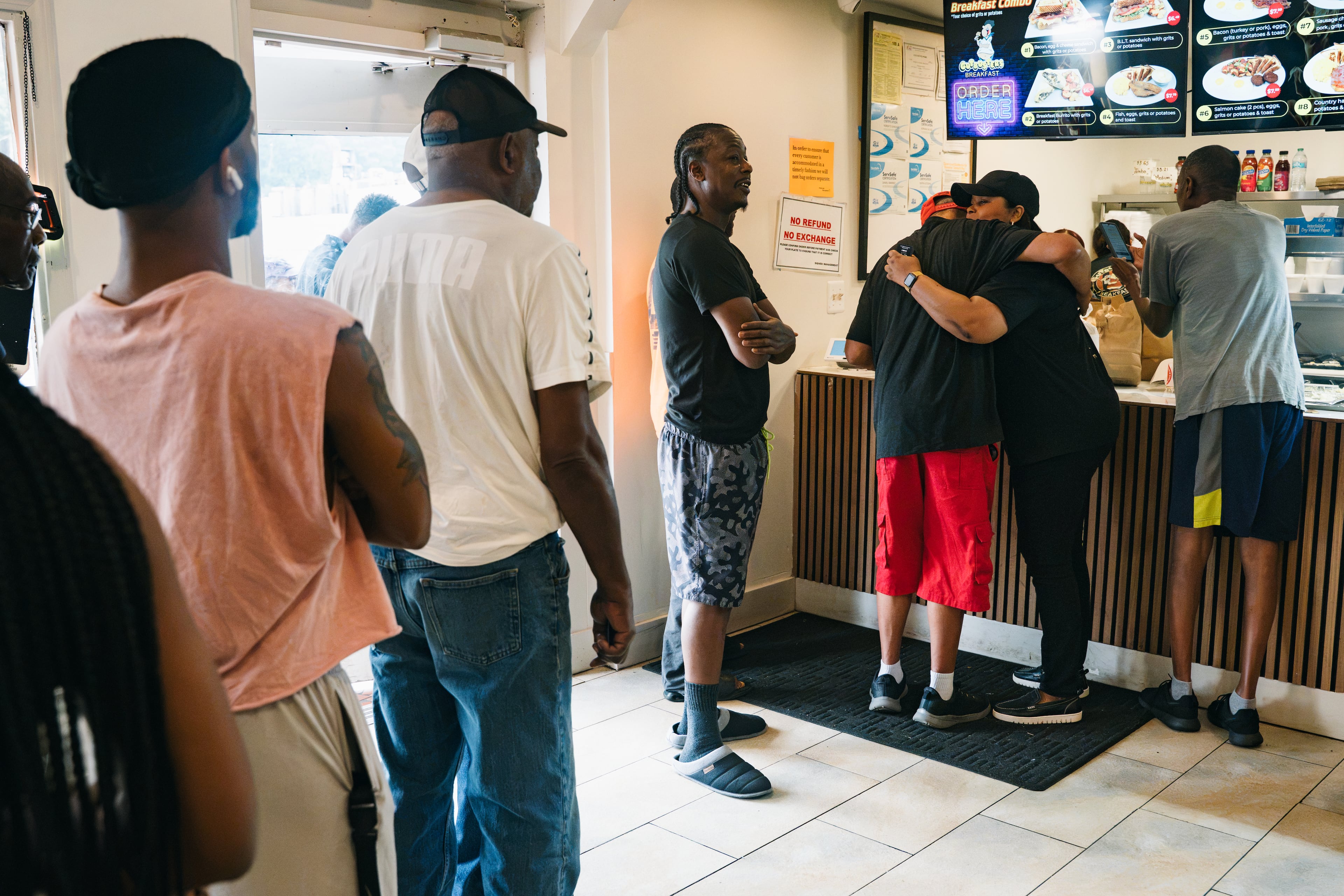 People wait in line to have their breakfast paid for during an outreach event hosted by Annette Groves and her religious organization, Bloom, at Gutbusters in Decatur on Saturday, July 25, 2026. The group hosts events like this monthly, with a goal of doing them every week. (Olivia Bowdoin for the AJC)