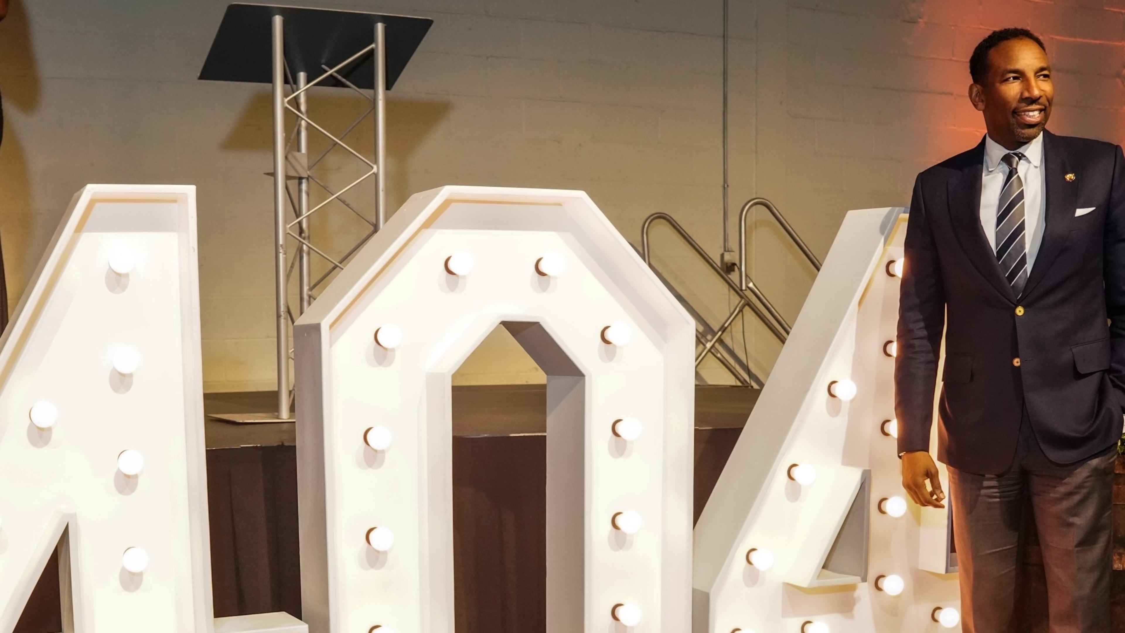 Atlanta Mayor Andre Dickens poses in front of a large "404" display at a scholarship gala raising funds for Atlanta students on April 3, 2024. (Josh Williams/AJC 2024)