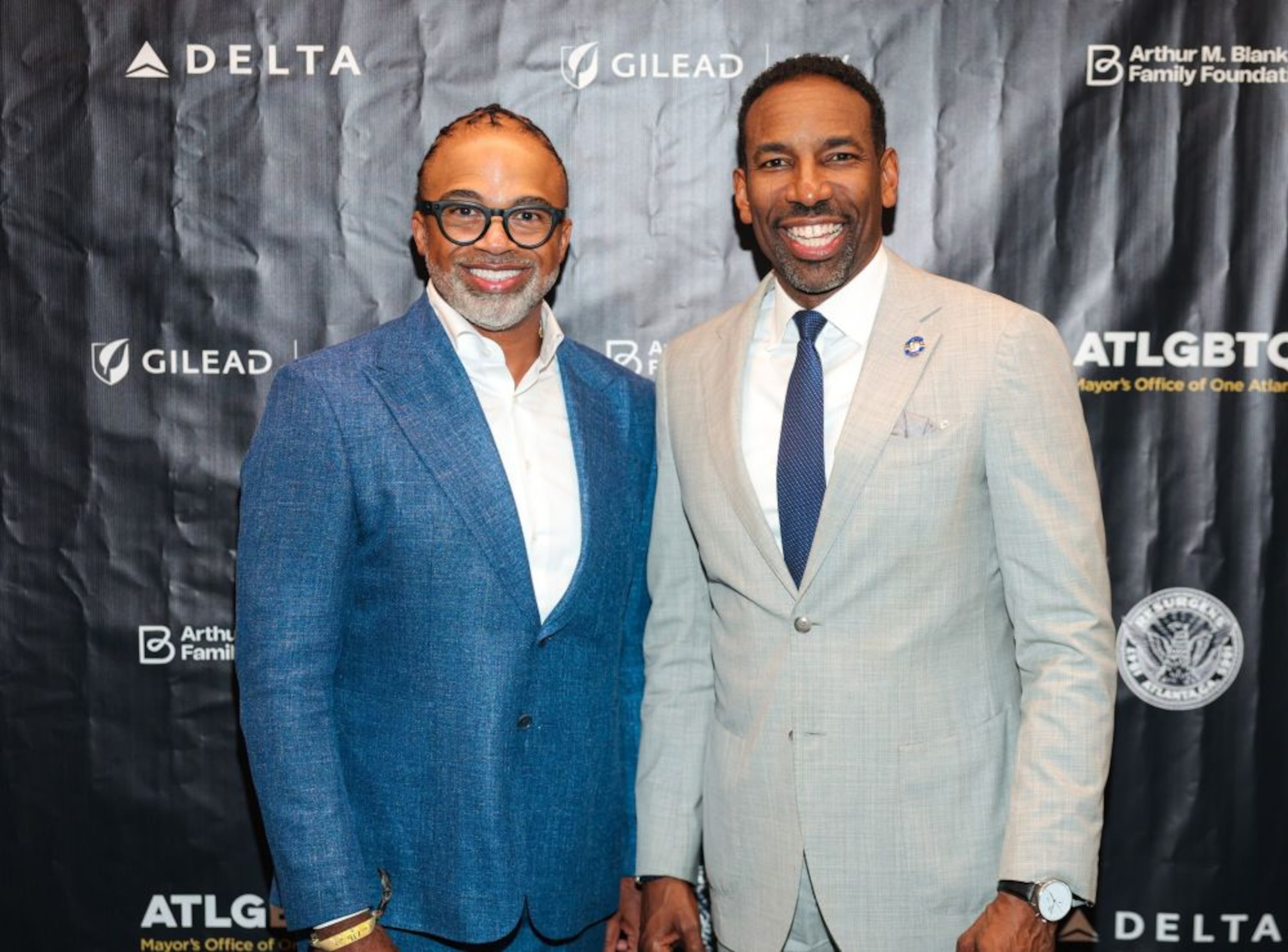 Rashad Burgess (left), vice president of corporate responsibility for Gilead Sciences, and Atlanta Mayor Andre Dickens attend the Mayor’s Black Pride Reception inside the City Hall Atrium on Thursday, Sept. 3, 2026. (Courtesy of Prince Williams for ATLPics)