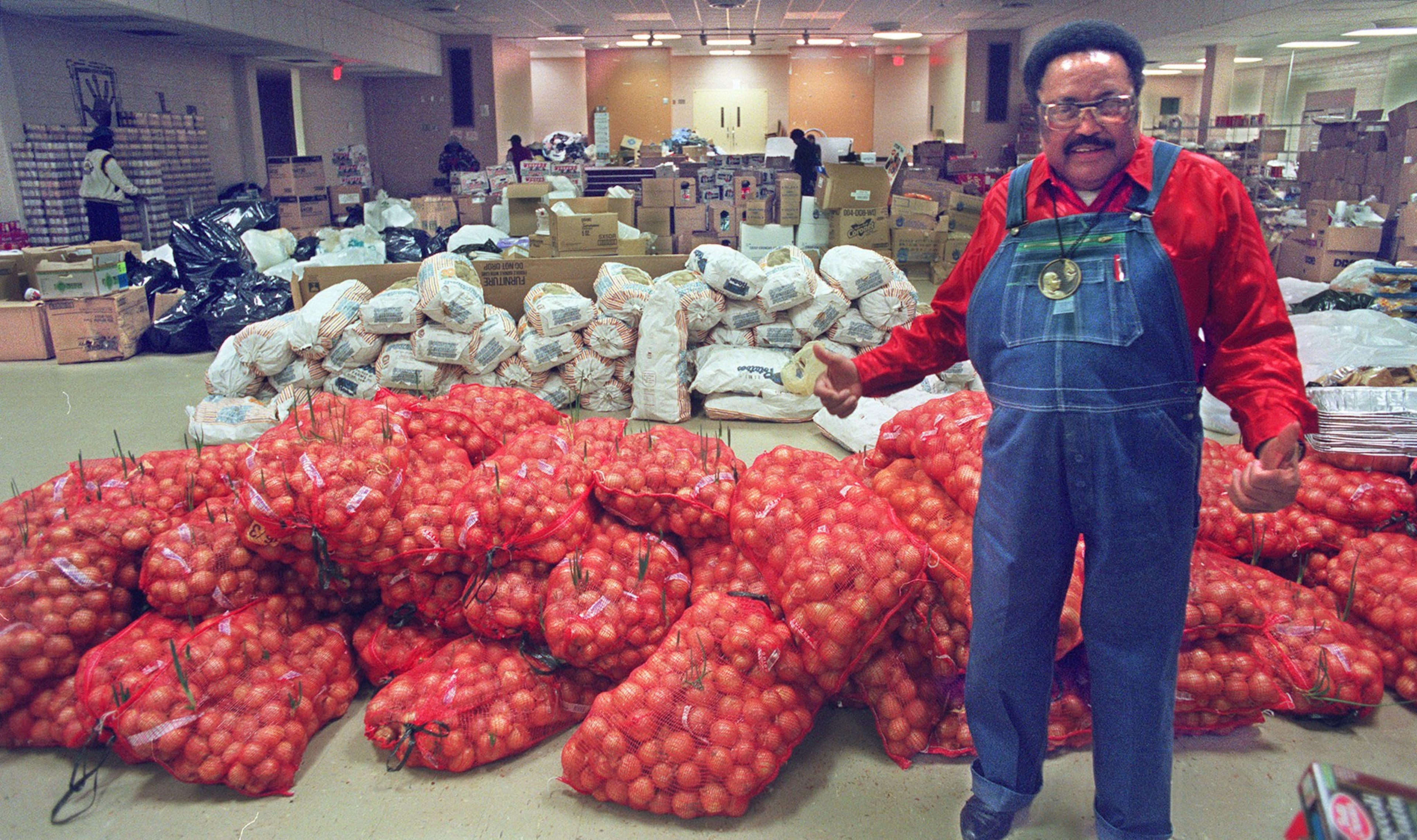 In his traditional red shirt and overalls, Hosea Williams fed thousands of Atlantans through his Hosea Feed the Hungry and Homeless program. (Nick Arroyo/AJC file)