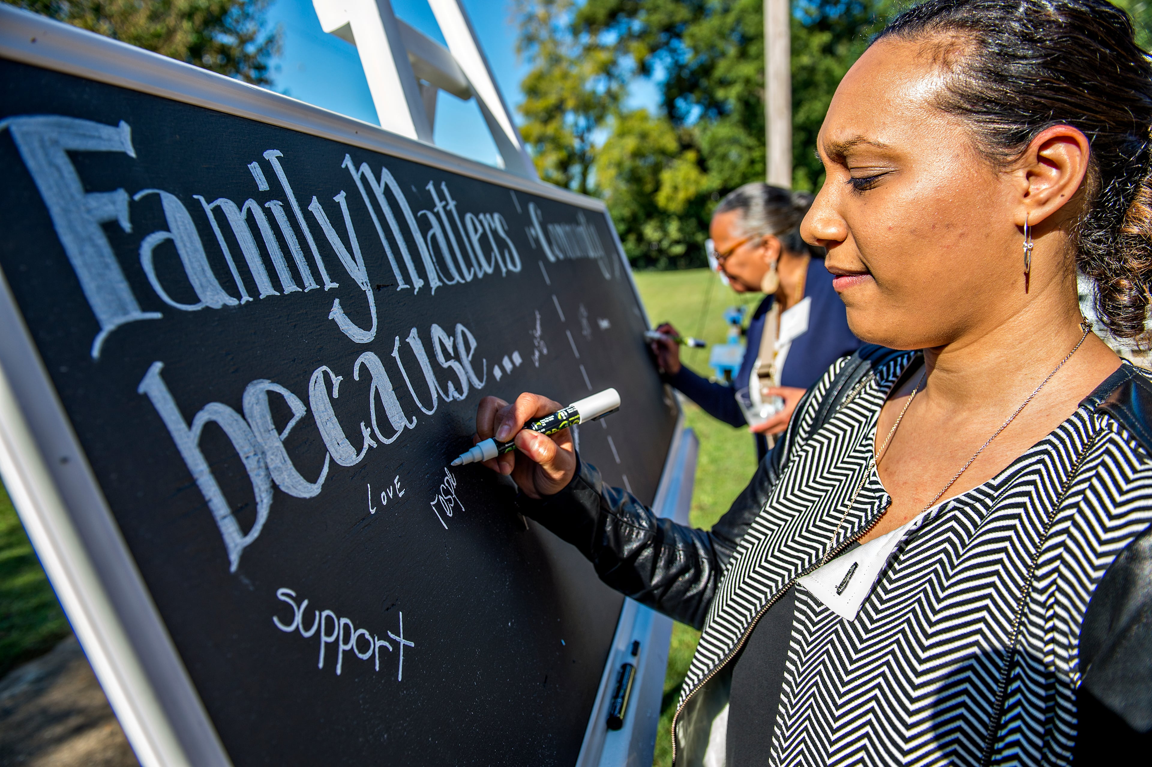 Nasim Fluker (right) and Robyn Sims fill in why family and community matter to them before the start of the Families First groundbreaking ceremony at the historic E.R. Carter Elementary School in Atlanta on Thursday, September 17, 2015. The school will become the new site of the Families First Resource Center. Families First is celebrating 125 years of helping Georgia families become self sufficient in a safe, stable and nurturing environement. JONATHAN PHILLIPS / SPECIAL