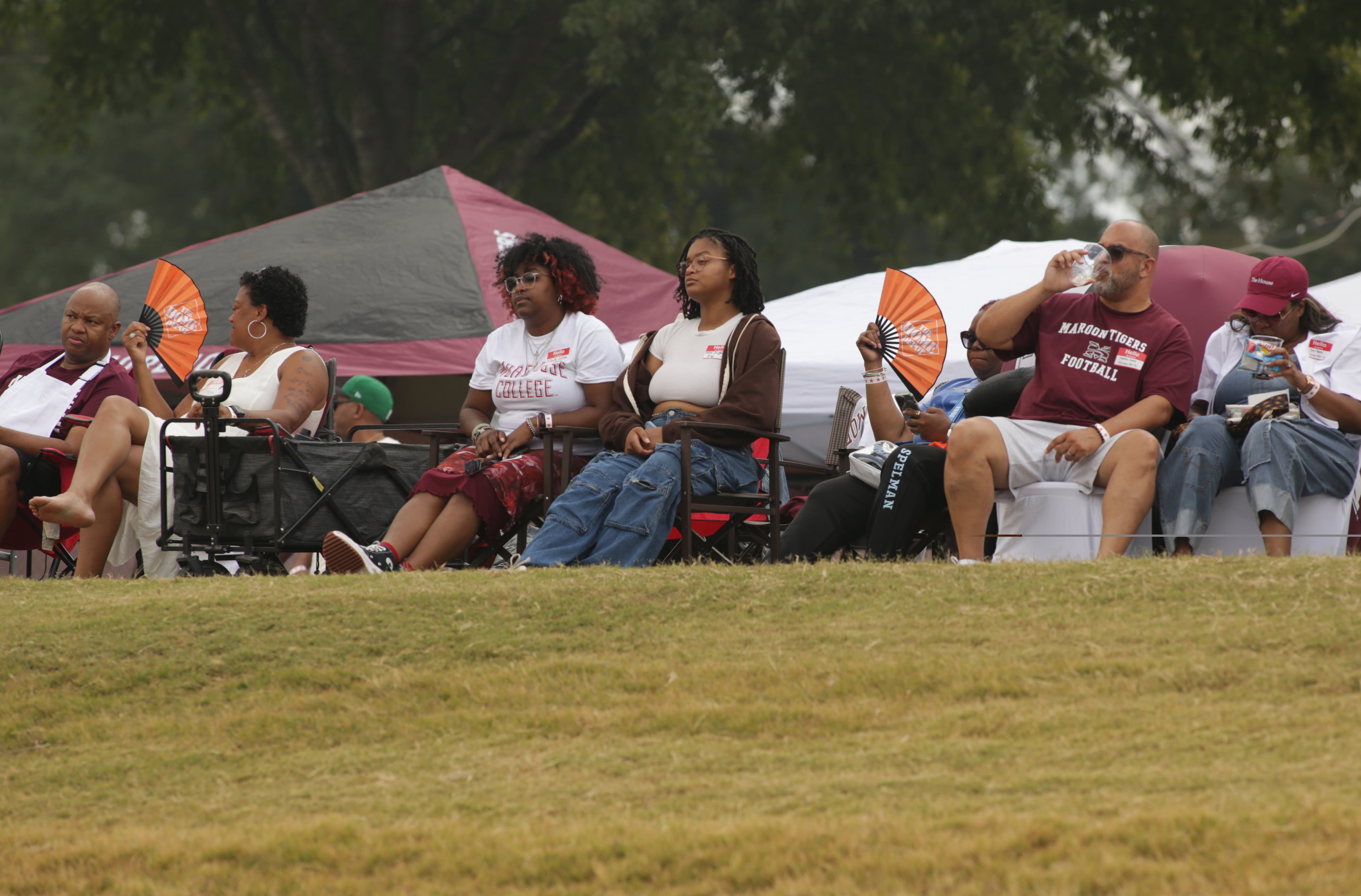 Morehouse homecoming tailgaters from outside the stadium watch the game. (Akili-Casundria Ramsess, EyeAkili Media for AJC)