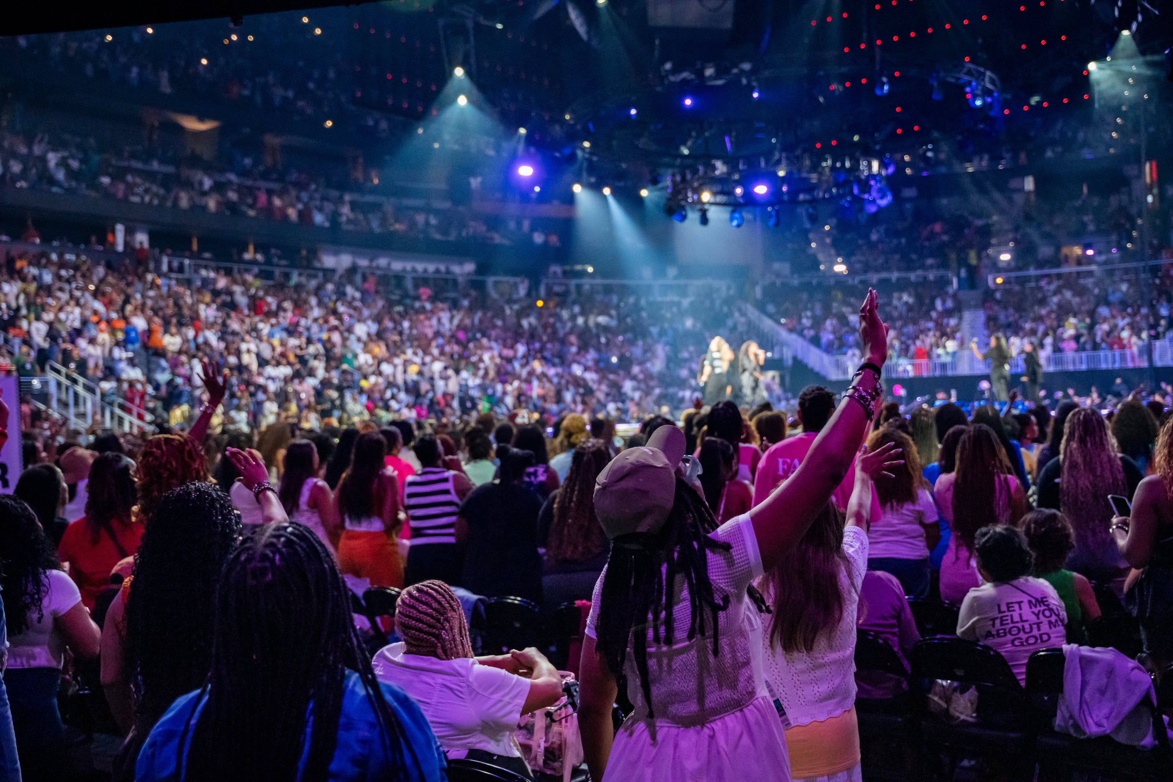 Women worship during the Woman Evolve conference, Thursday, Aug. 1, 2025, in Atlanta. The event marks the first Woman Evolve conference in Atlanta since Pastor Sarah Jakes Roberts and her husband assumed leadership of The Potter’s House from her father, Bishop T.D. Jakes. (Olivia Bowdoin for the AJC)