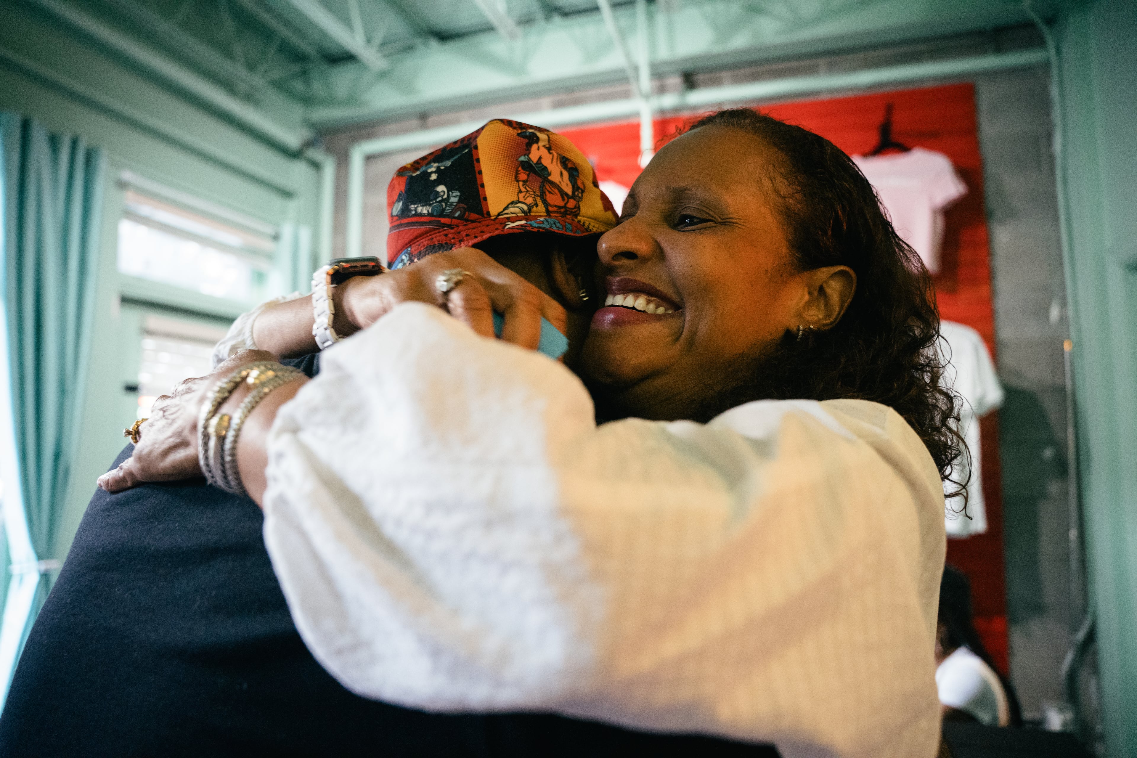 Museum executive and friend Kama Pierce hugs artist Fabian Williams during a preview of “Mothership Sirius B” on Aug. 12, 2026, in Atlanta. Williams created the immersive exhibit with his wife, Sindy Guerrero-Williams. (Olivia Bowdoin/AJC)