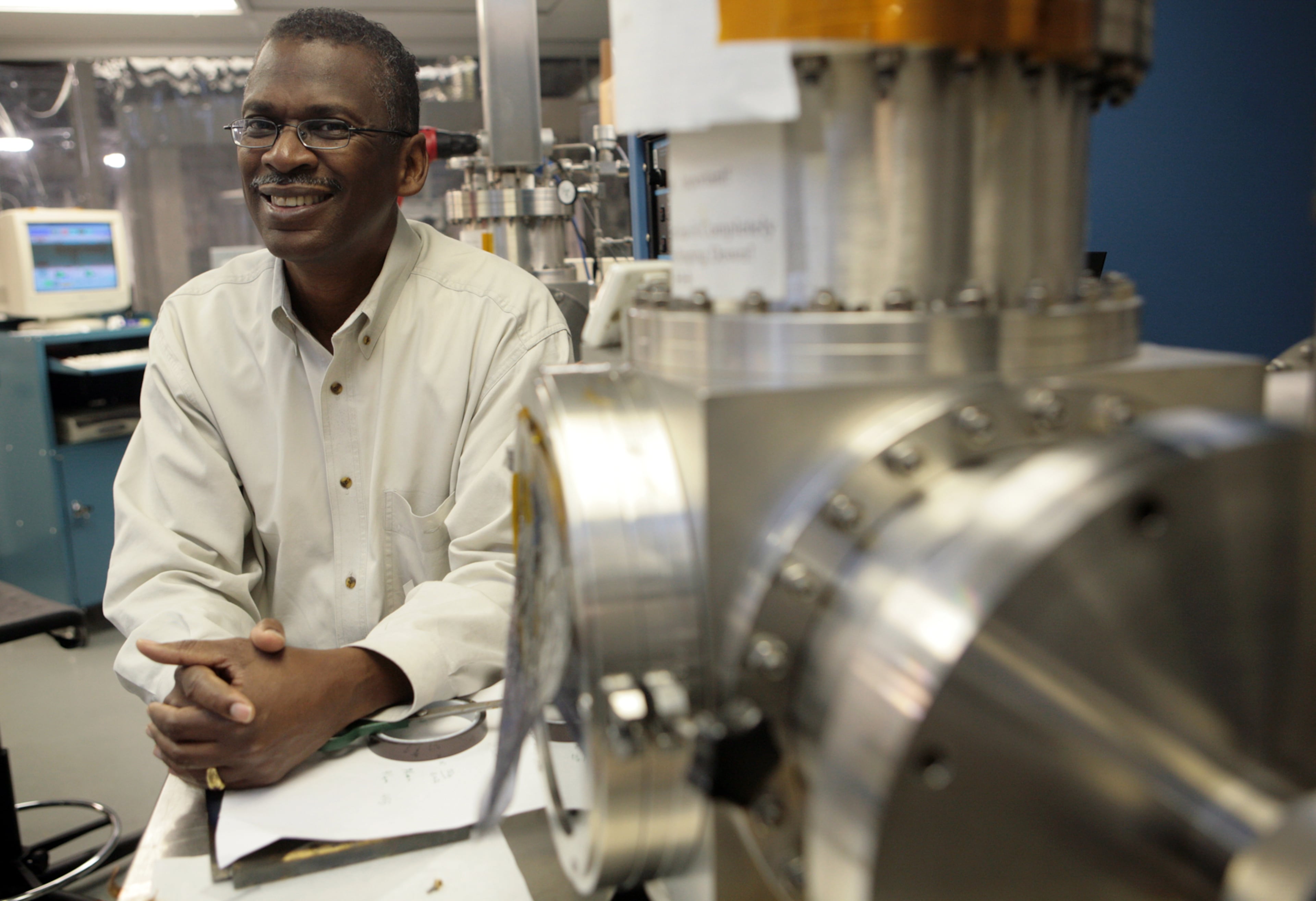 Atlanta inventor Lonnie Johnson, the creator of the Super Soaker, stands next to a sputtering system machine in his labs in downtown Atlanta on Oct. 20, 2008. (AJC File Photo)