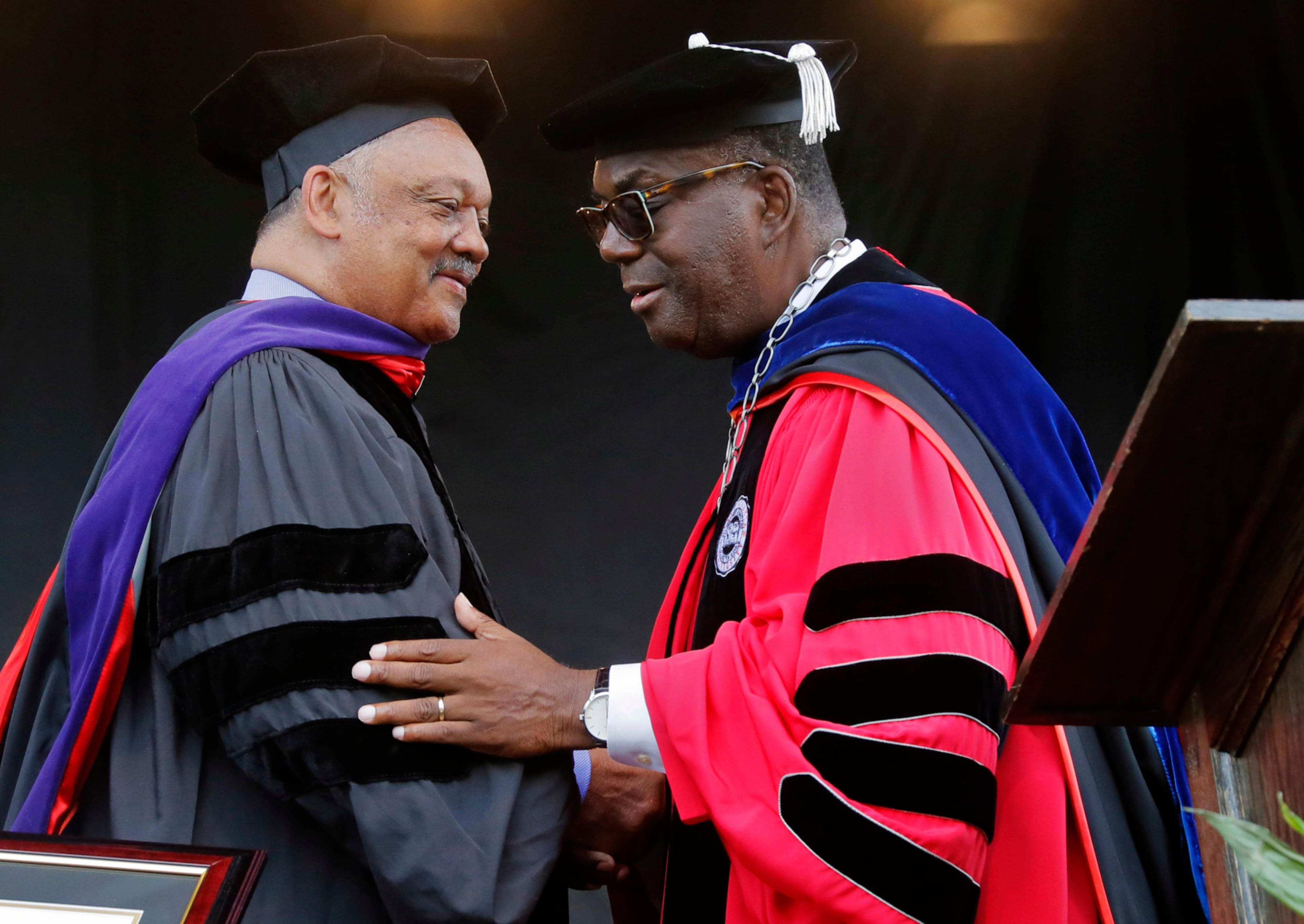 Jackson, is congratulated by Clark Atlanta University President Ronald Johnson after he received an honorary degree at Clark's 28th annual commencement. Jackson also spoke at the ceremony. (Bob Andres/AJC 2017)