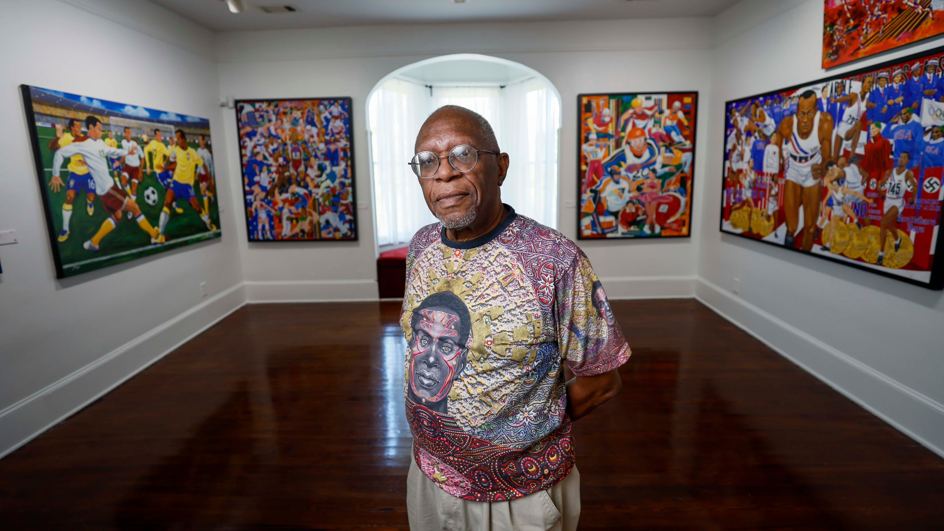 Visual artist Steve Allen poses on the second floor of one of his exhibits at the Hammonds House Museum on Thursday, August 20, 2026. Allen’s exhibit comprises two parts. Downstairs is “Infinite Inheritance,” and upstairs is “O Jogo Bonito (The Beautiful Game).” The downstairs section explores Black ancestry, while the upstairs exhibition features works inspired by the Olympic Games. (Miguel Martinez/AJC)