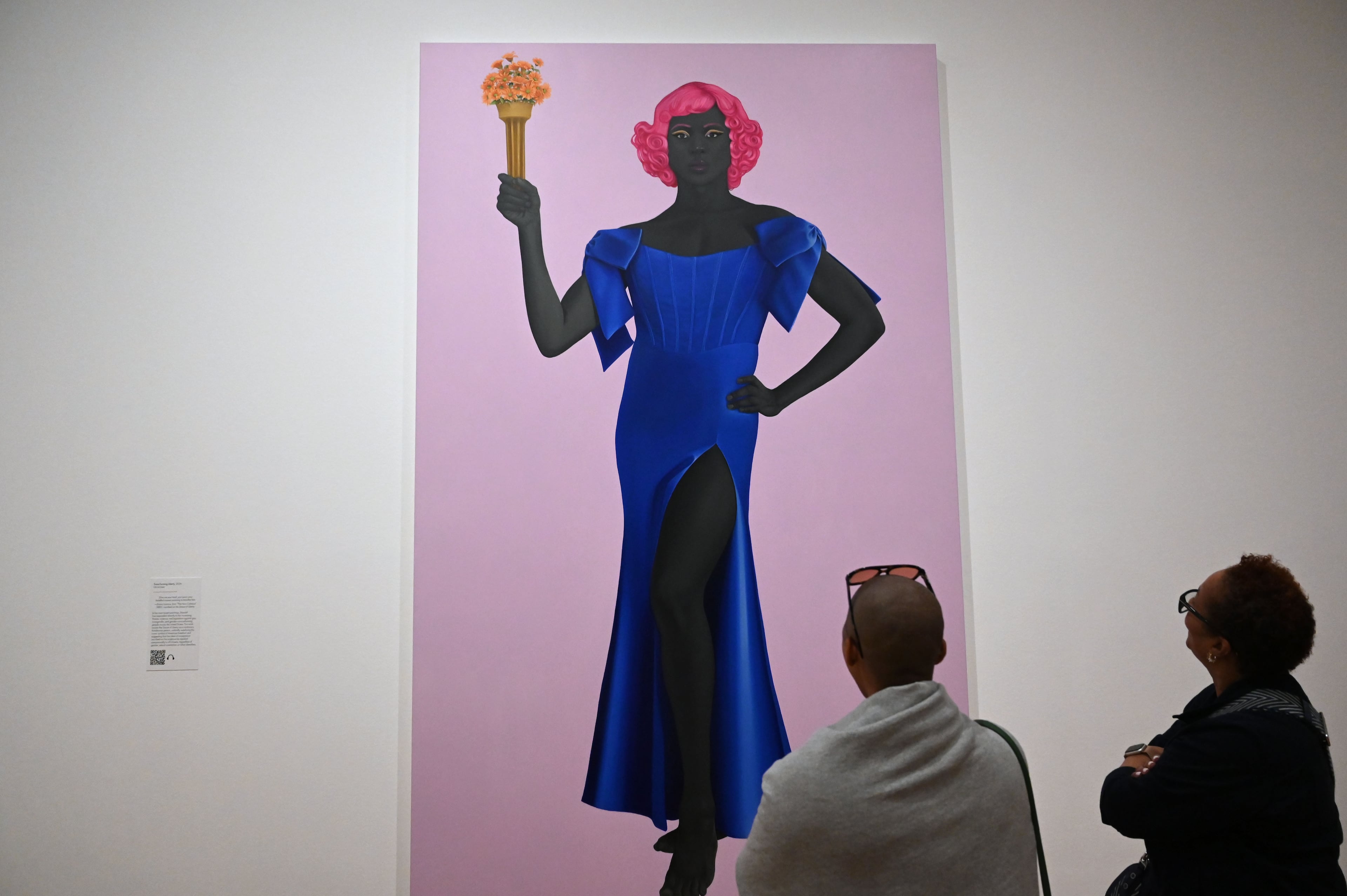 The satin on the blue corset dress in “Trans Forming America,” a modern take on the Statue of Liberty, transcends the portrait. (Hyosub Shin/AJC)