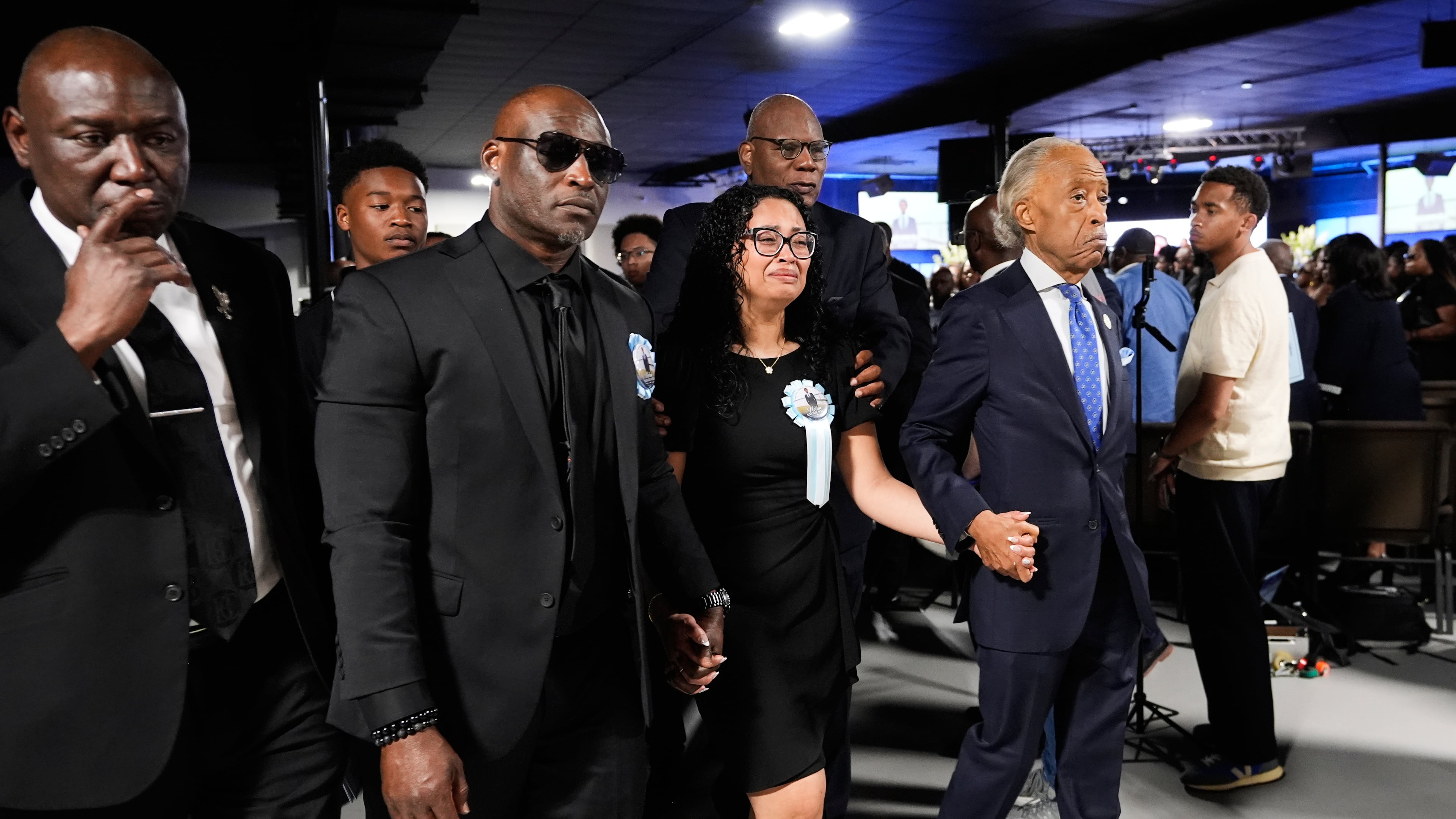 Christine Wonsley, center, walks with Rev. Al Sharpton, right, her husband Elmore, second from left, and attorney Ben Crump, left, during a memorial service for her son Nolan Xavier Wells, an 18-year-old found dead after taking a July 4 boat trip with friends, Monday, July 20, 2026, in Ocean Springs, Miss. (Gerald Herbert/AP)