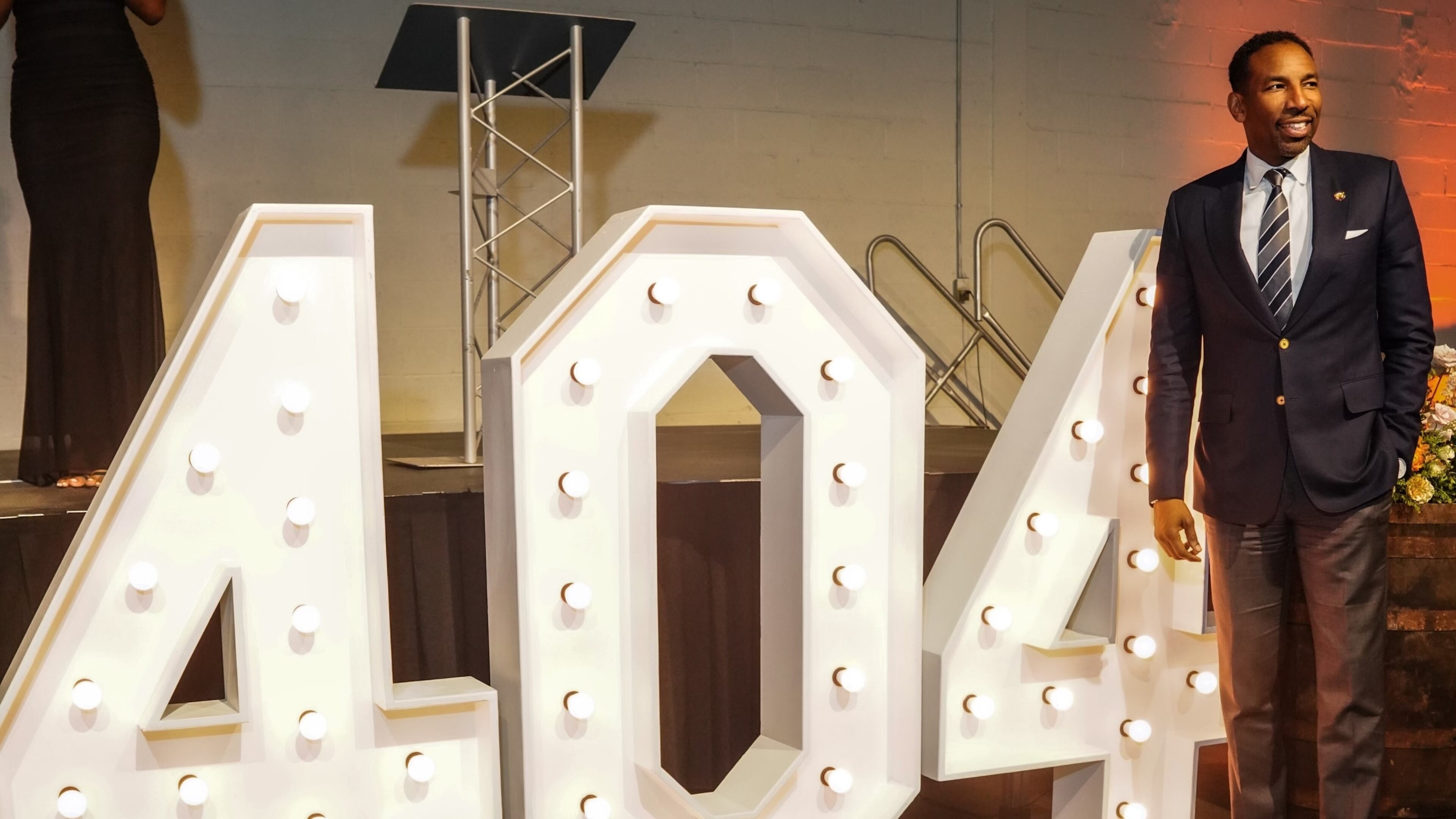 Atlanta Mayor Andre Dickens poses in front of a large "404" display at a scholarship gala raising funds for Atlanta students on April 3, 2024. (Courtesy of 404 Collective)
