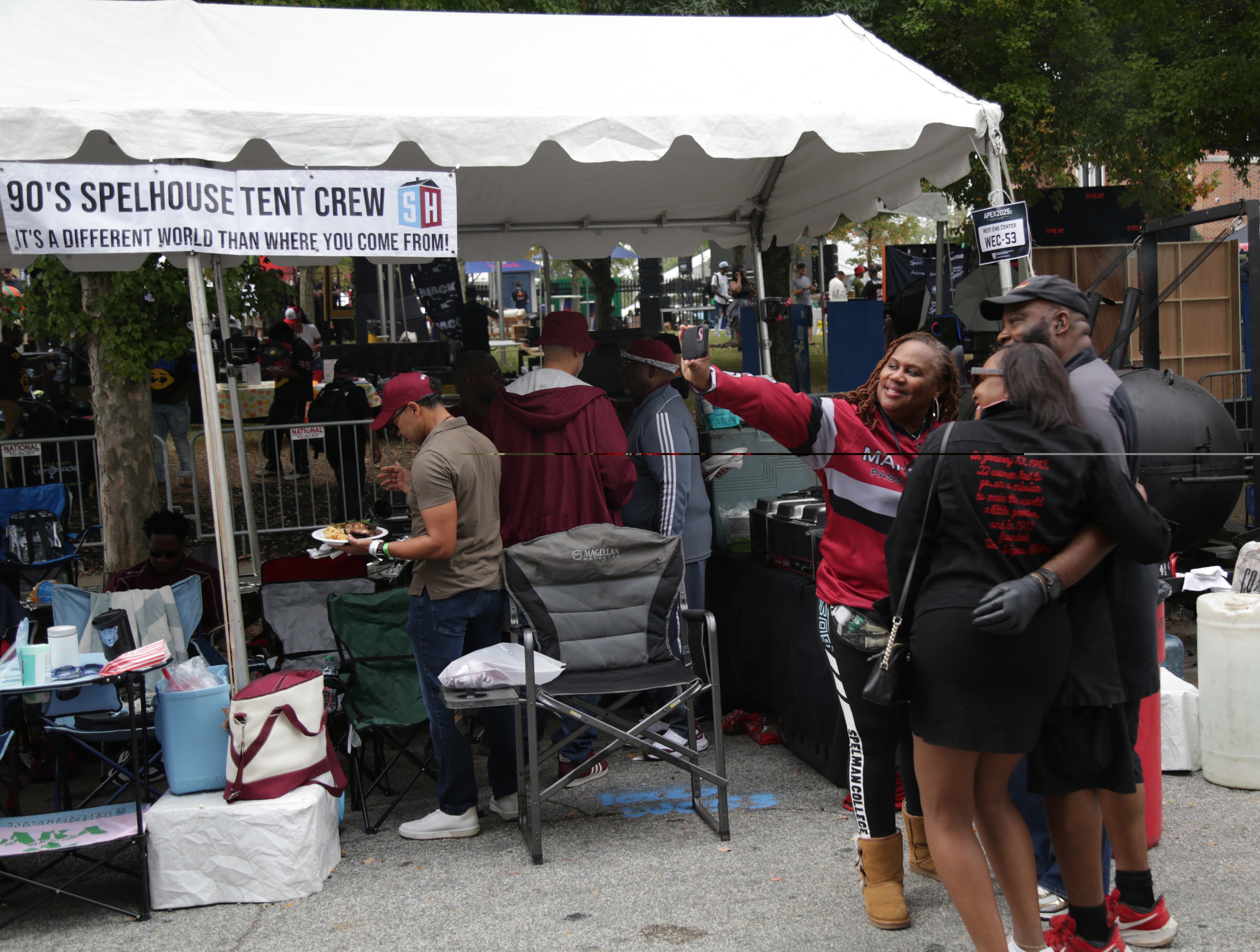 Nikita Patterson (left) and Jamie Antoine with their tent chef, Eddie S. Henderson Jr. Patterson is an alum of Spelman class of 1993. They are part of a tailgating group of friends of Morehouse and Spelman 1990’s alums that have a tailgating tent where they celebrate at the Morehouse Homecoming. (Akili-Casundria Ramsess for the AJC)