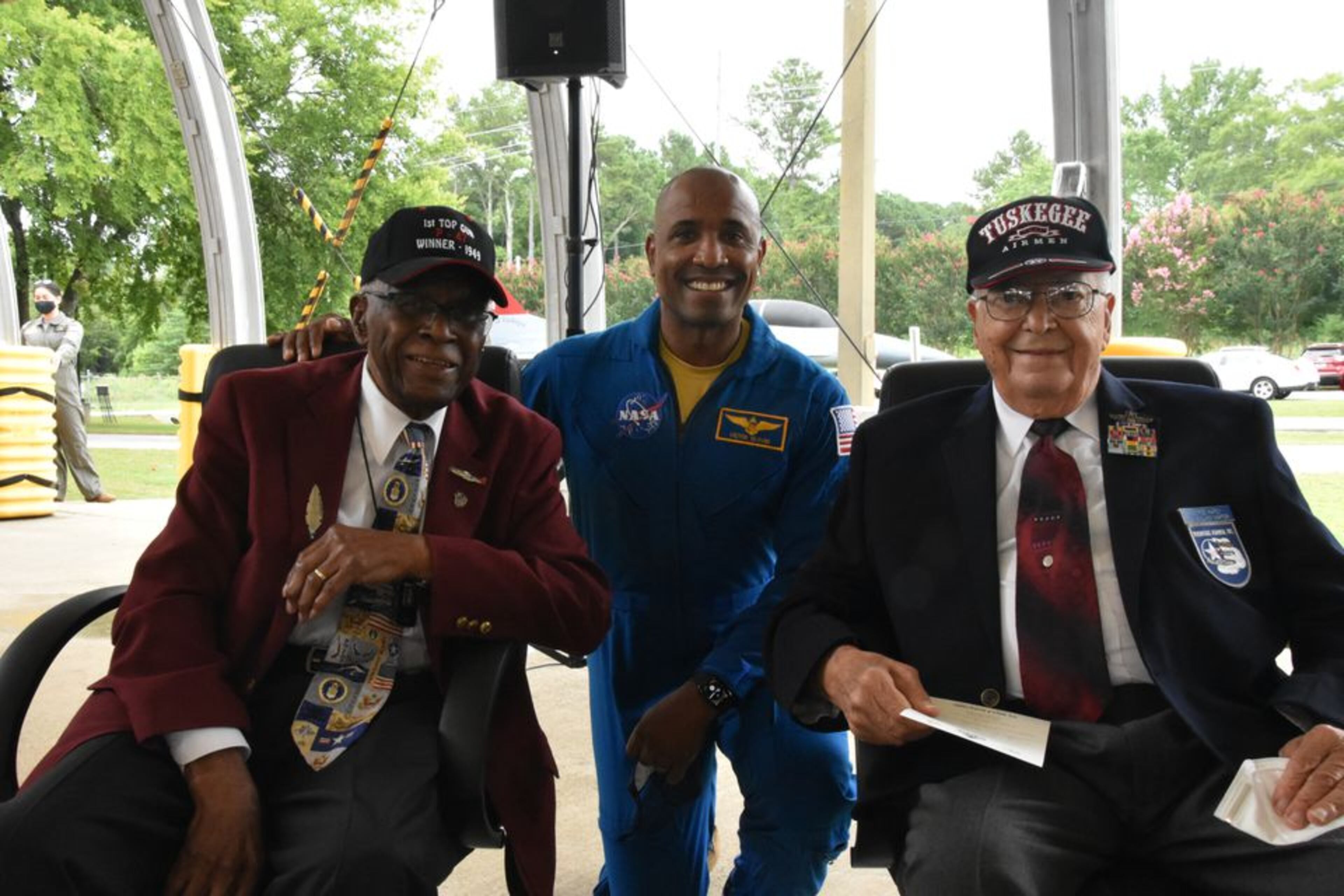 NASA astronaut Victor Glover Jr., center, is flanked by former Tuskegee Airmen Lt. Col. James Harvey, left, and Lt. Col. George Hardy, right, at the U.S. Space & Rocket Center in Huntsville, Ala., in early August 2021. All three were gathered to honor the airmen on the 30th anniversary of the rocket center's Aviation Challenge program. Harvey, who participated in the inaugural Continental Air Gunnery Meet in 1949, had pressed the Air Force to honor the victory by his team, the 332nd Fighter Group - the unit of the Tuskegee Airmen. (Courtesy of Lee Roop/AL.com)