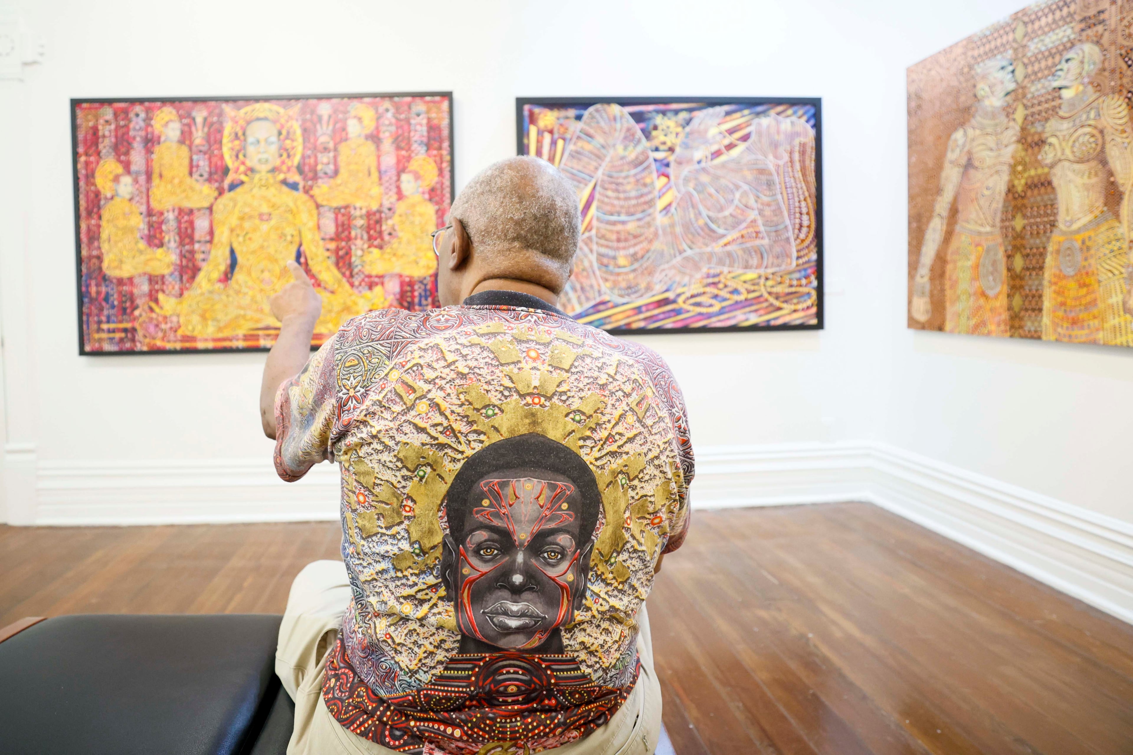 Visual artist Steve Allen is seen explaining the elements and inspiration behind the paintings in his exhibit at the Hammonds House Museum on Thursday, August 20, 2026. (Miguel Martinez/AJC)