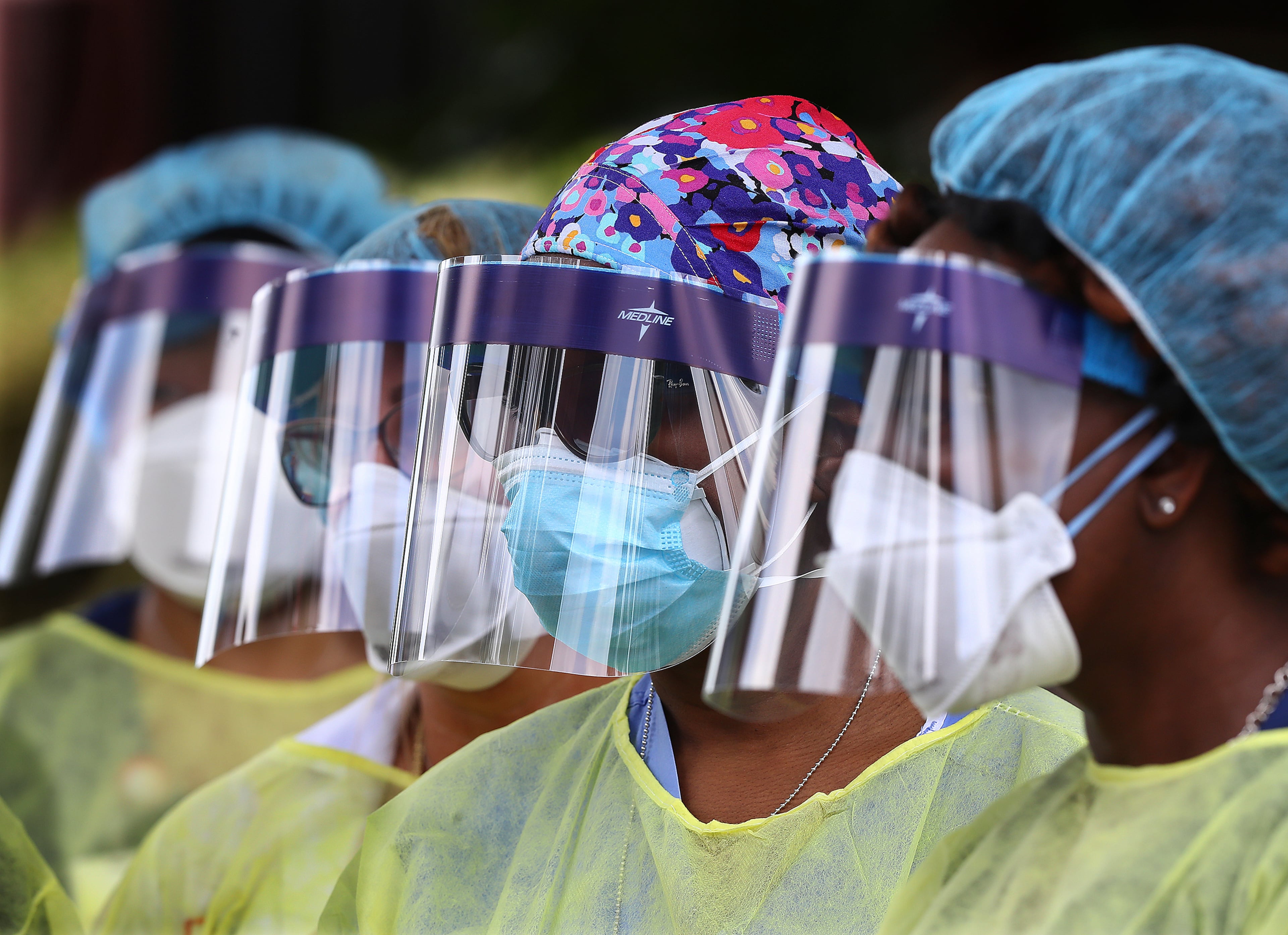 In this May 4, 2020, file photo, volunteers line up to begin taking hundreds of free COVID-19 tests at a pop-up site at the House of Hope in Decatur, Ga. Many African Americans watching protests calling for easing restrictions meant to slow the spread of the new coronavirus see them as one more example of how their health, their safety and their rights just don't seem to matter. (Curtis Compton/AJC)