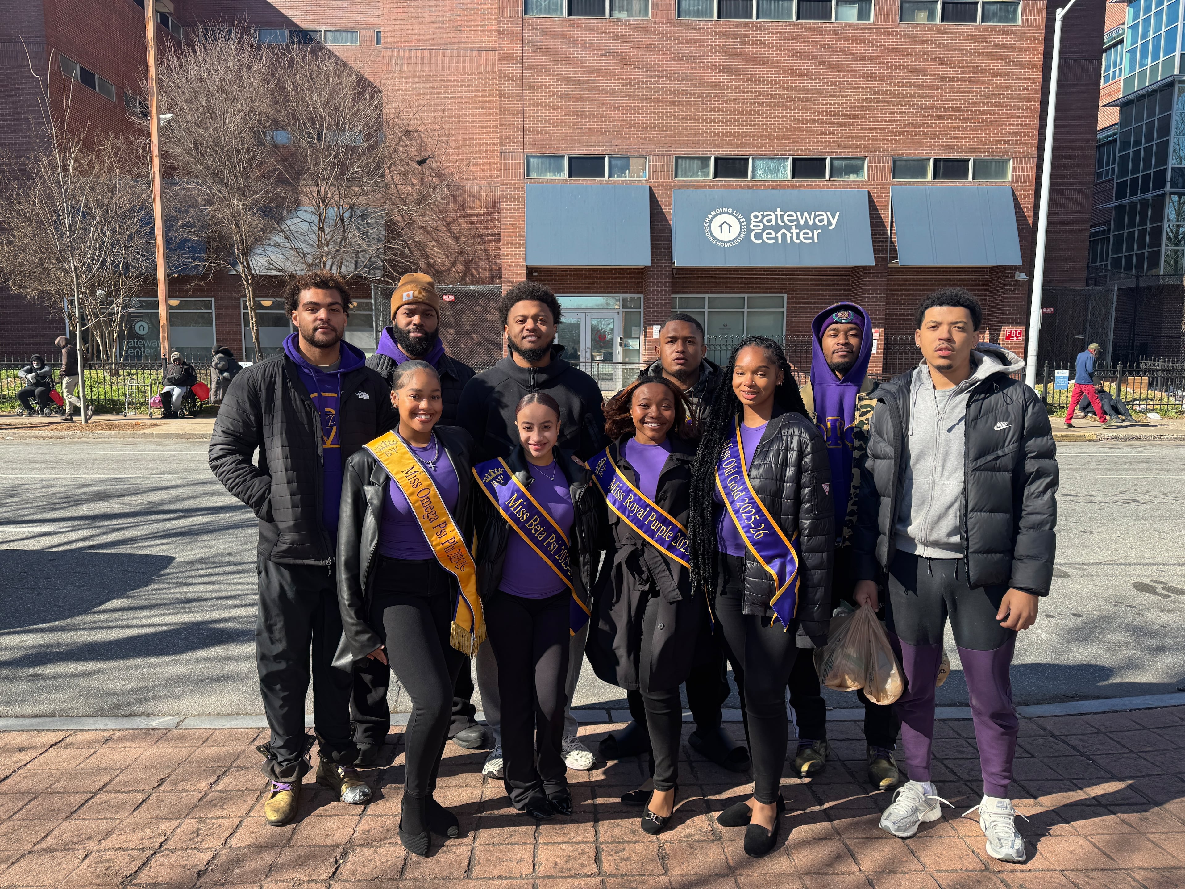 Clark Atlanta University student Morgan Lee Gamble (front, left) stands with members of the Miss Omega Psi Phi royal court and members of the Beta Psi Chapter of Omega Psi Phi Fraternity Inc., outside the Gateway Center homeless shelter in Atlanta. (Courtesy of Charli Jackson)
