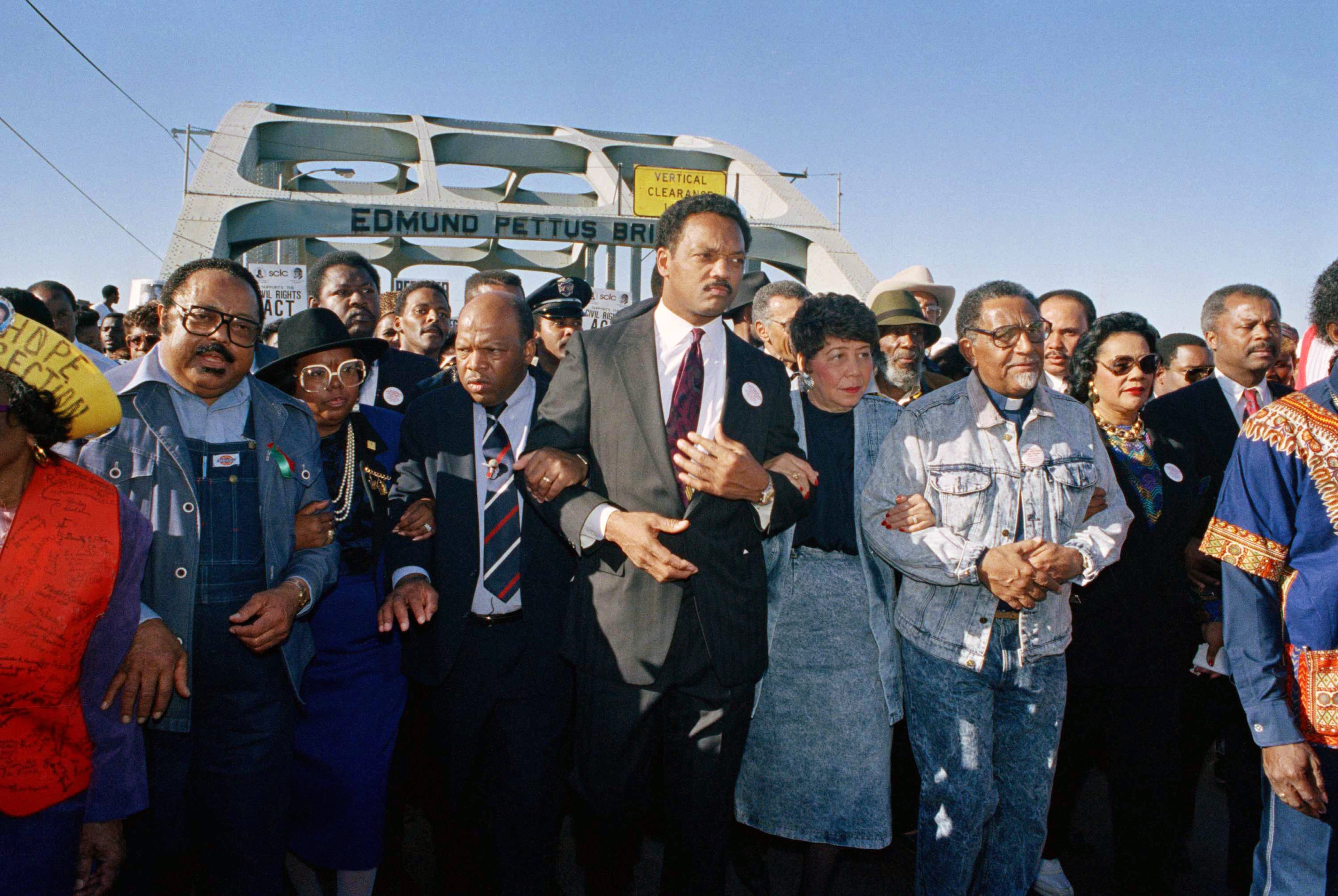Civil rights figures lead marchers across the Edmund Pettus Bridge during the recreation of the 1965 Selma to Montgomery march in Selma, Ala., on March 4, 1990. From left are Hosea Williams of Atlanta, Georgia Congressman John Lewis, the Rev. Jesse Jackson, Evelyn Lowery, SCLC President Joseph Lowery and Coretta Scott King (glasses). (Jamie Sturtevant/AP)
