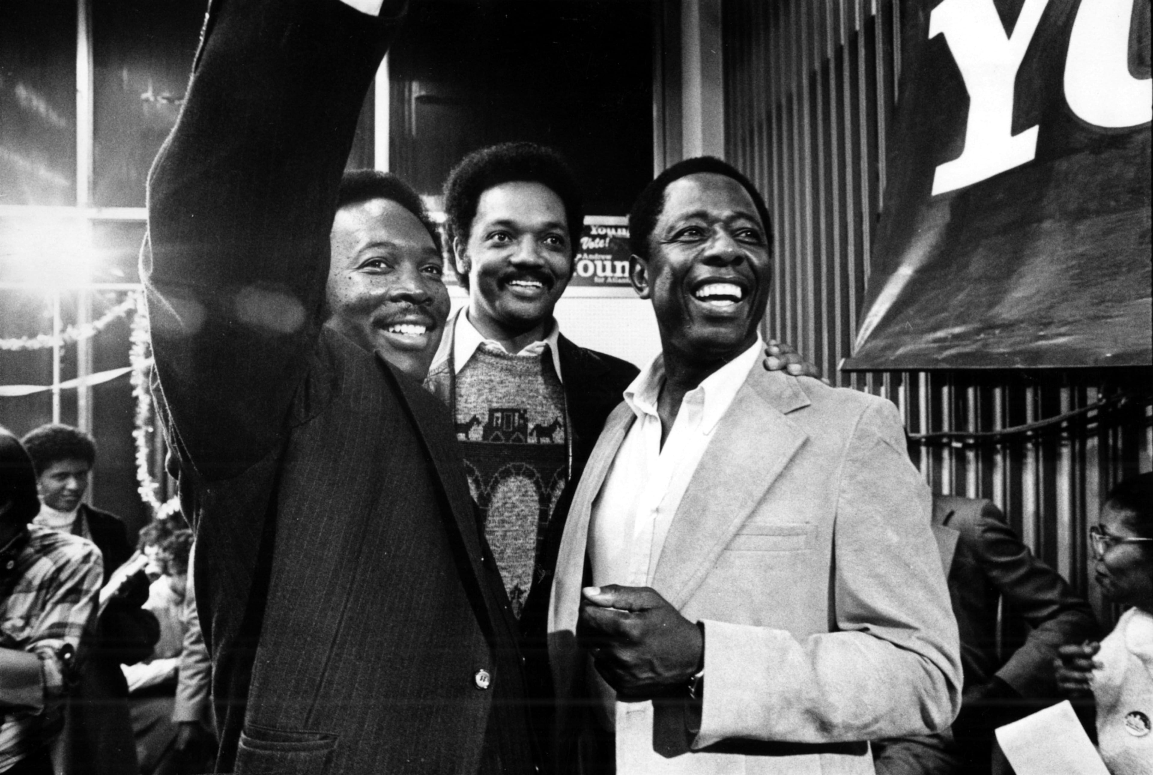 Reginald Eaves (from left), Jesse Jackson and Henry 'Hank' Aaron are all smiles atAndrew Young's campaign headquarters after his election as mayor of Atlanta. (Louie Favorite/AJC 1981)