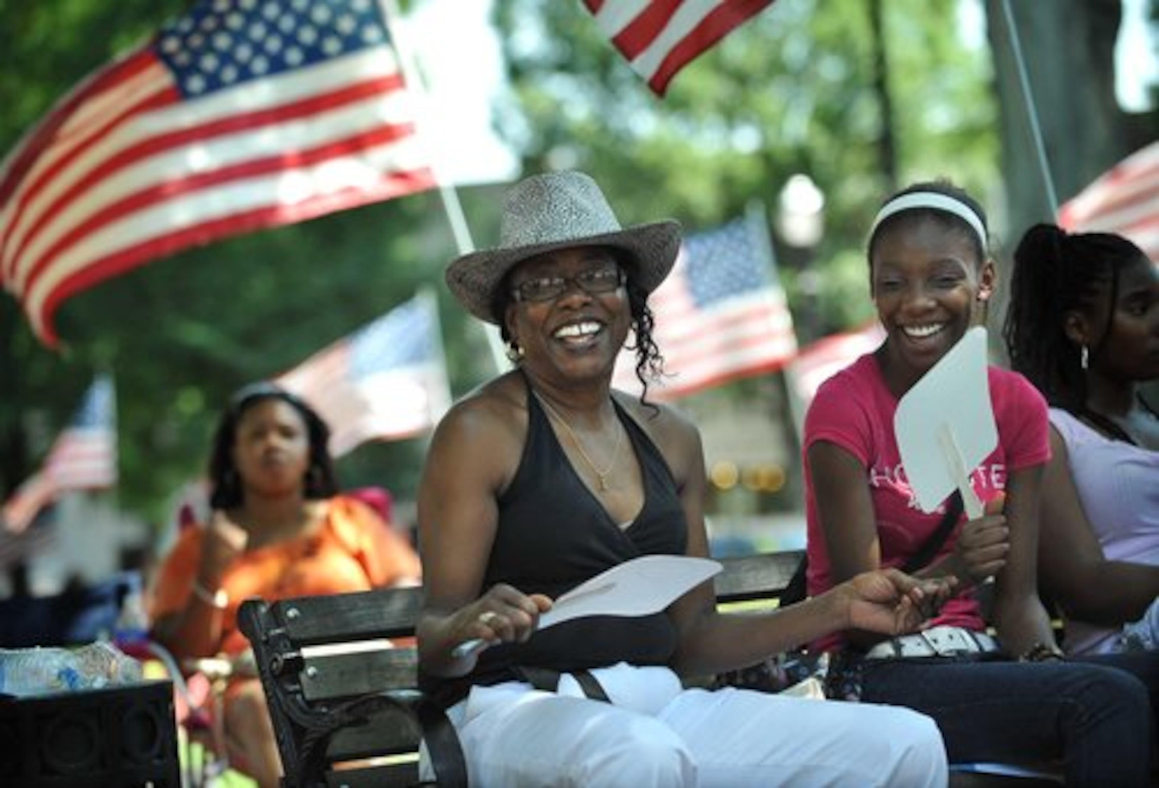Diana Griffian (front left), of Smyrna and her granddaughter Courtney Johnson (right), 16, of Mableton listen to music. (Hyosub Shin.AJC)